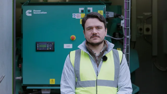 Film frame of the Terra Firma representative beside the generator enclosures