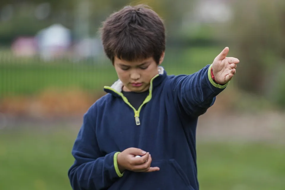 Child pointing during an outdoor discovery session