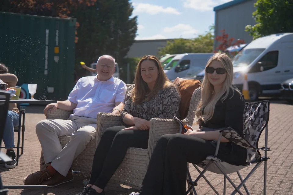 Guests seated in camping chairs chatting