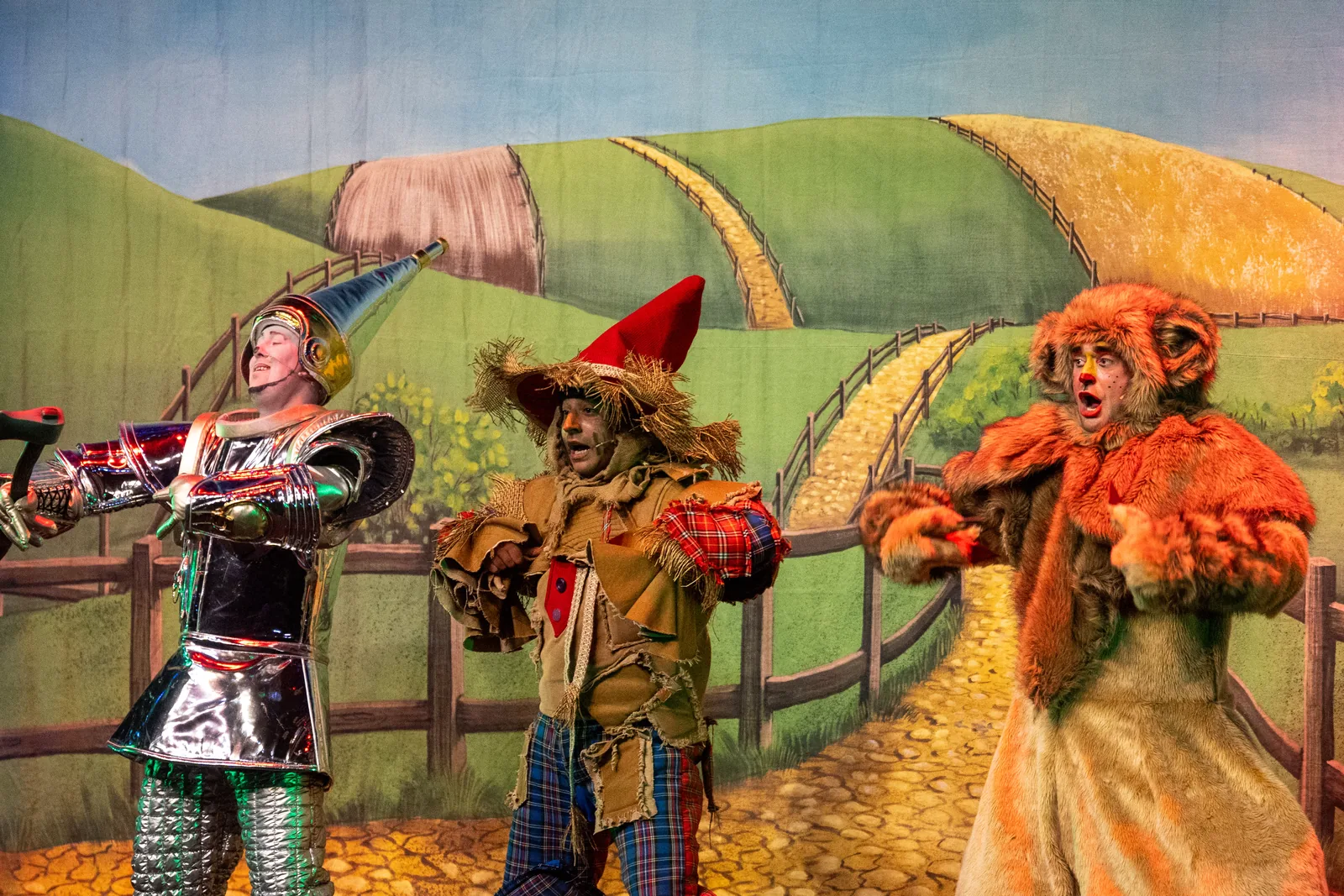 The Tin Man, Scarecrow and Lion performing together
