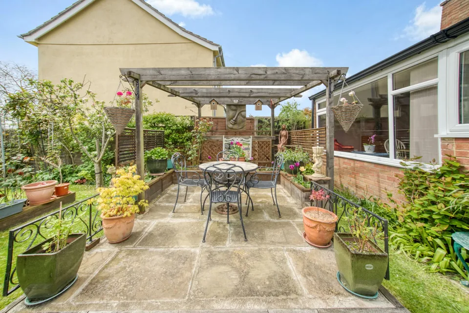 Patio dining area beneath a timber pergola in Cavendish