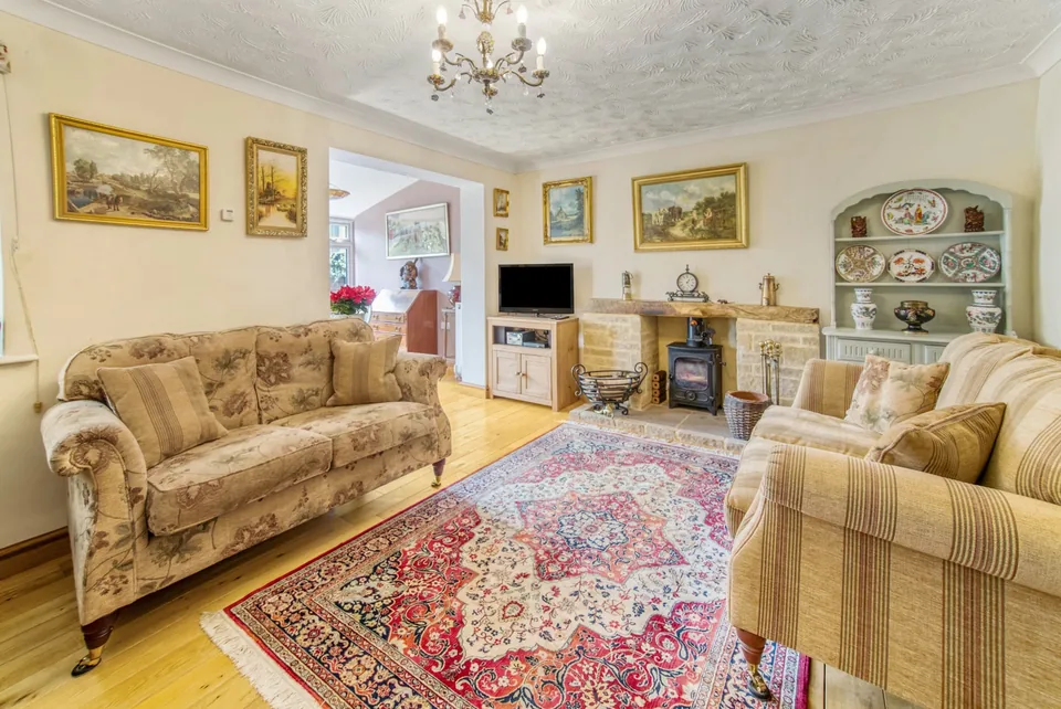 Living room with patterned sofas and a fireplace in Cavendish