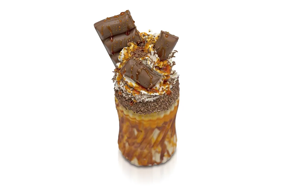 Loaded chocolate freakshake photographed on white