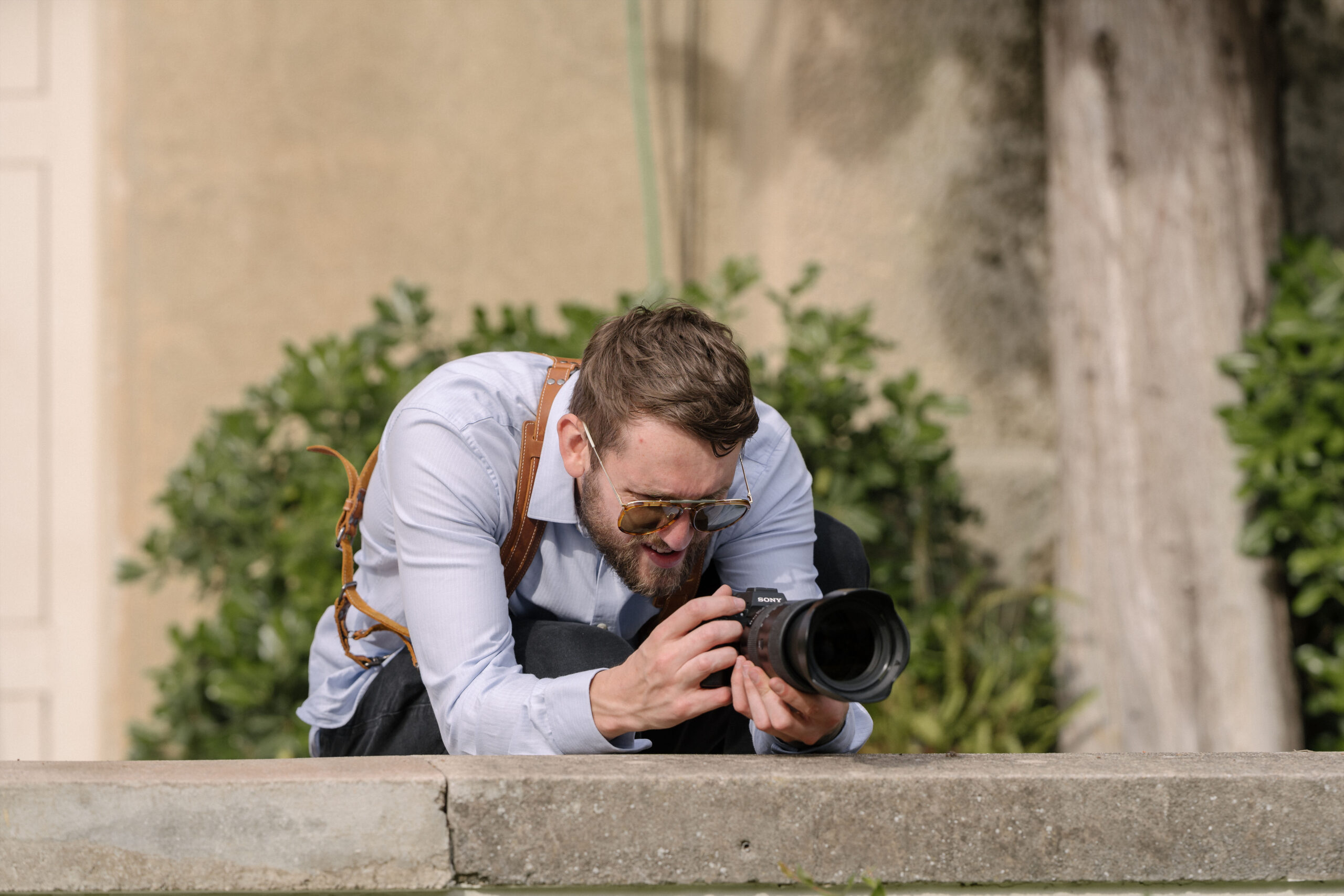 Sam filming a wedding production on location