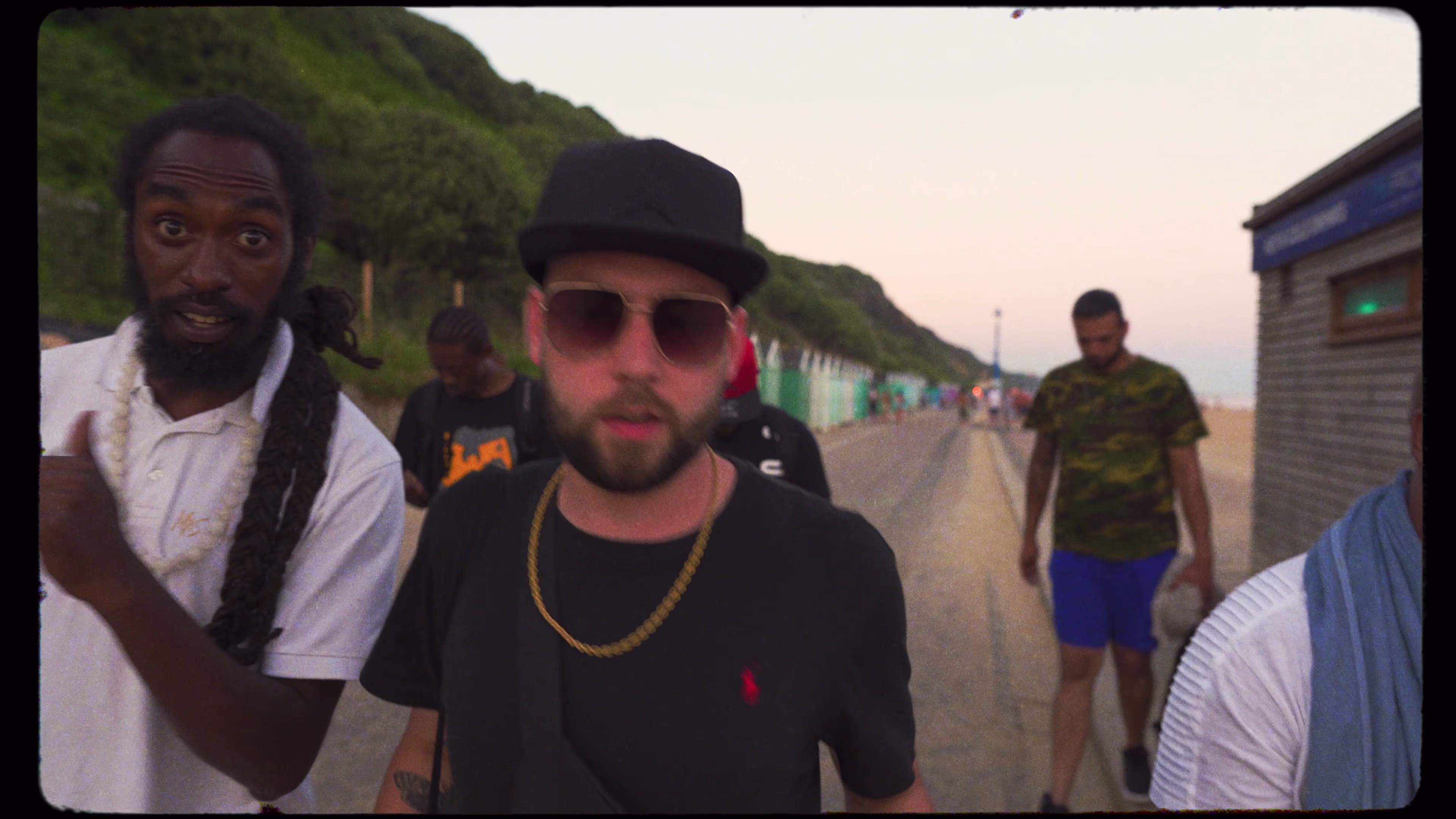 Performers moving between locations during the coastal shoot