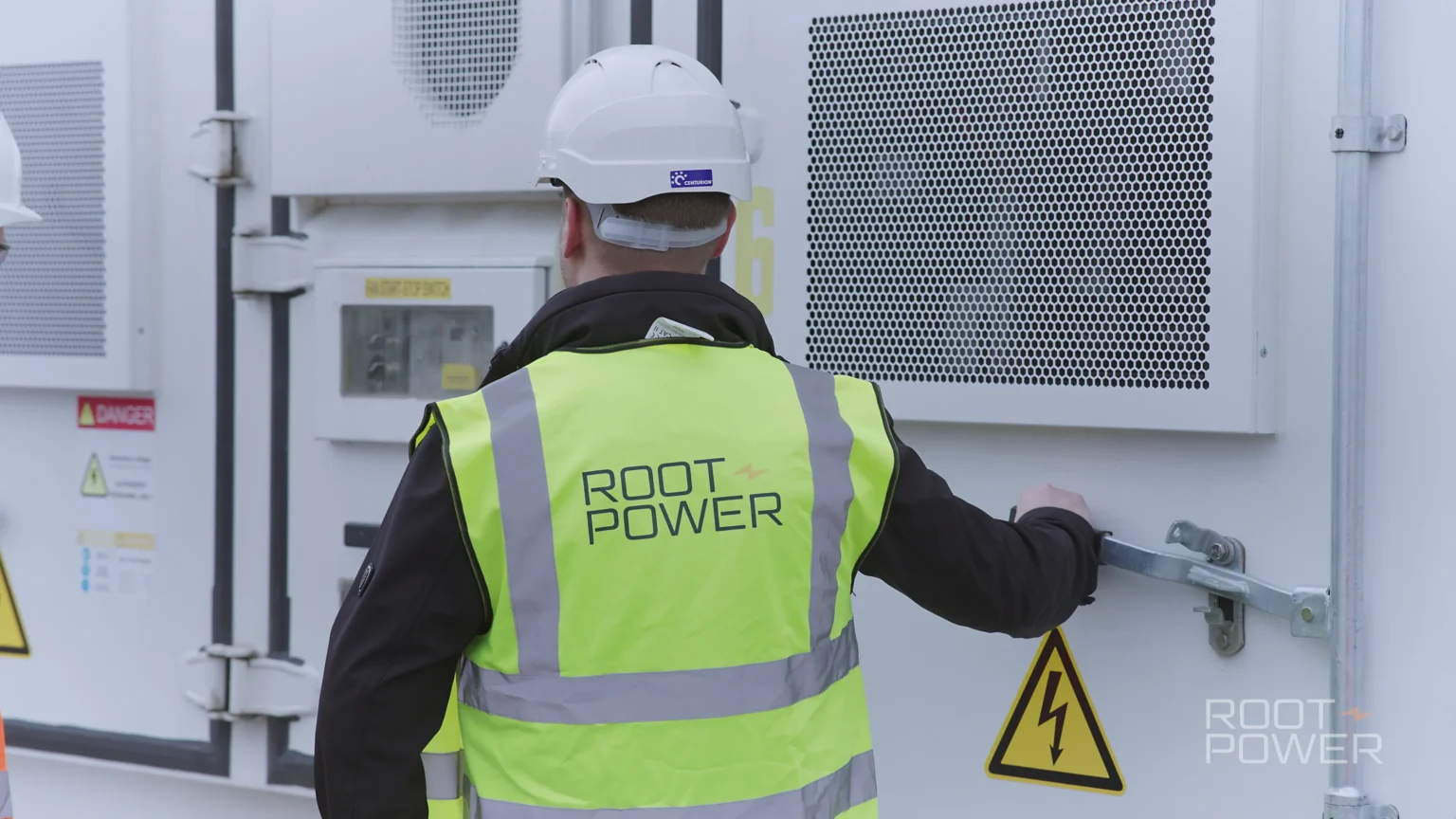 Root-Power team member inspecting battery storage equipment at Coryton BESS