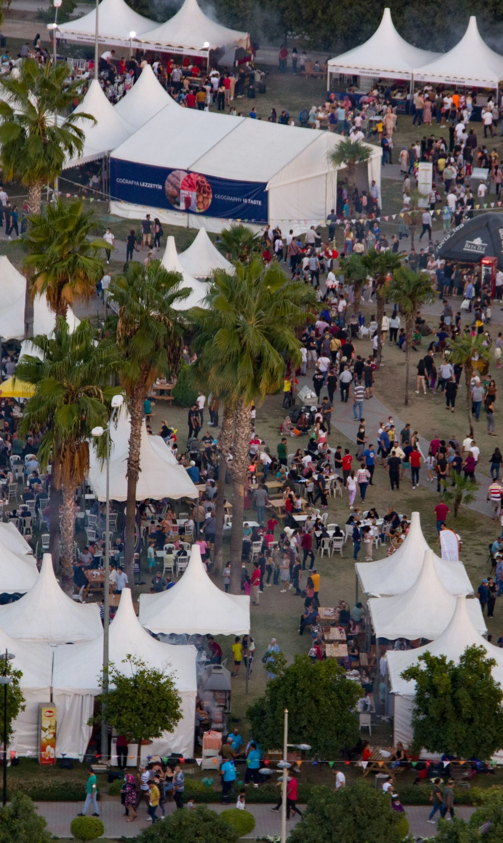 An outdoor festival and its grounds viewed from an elevated position