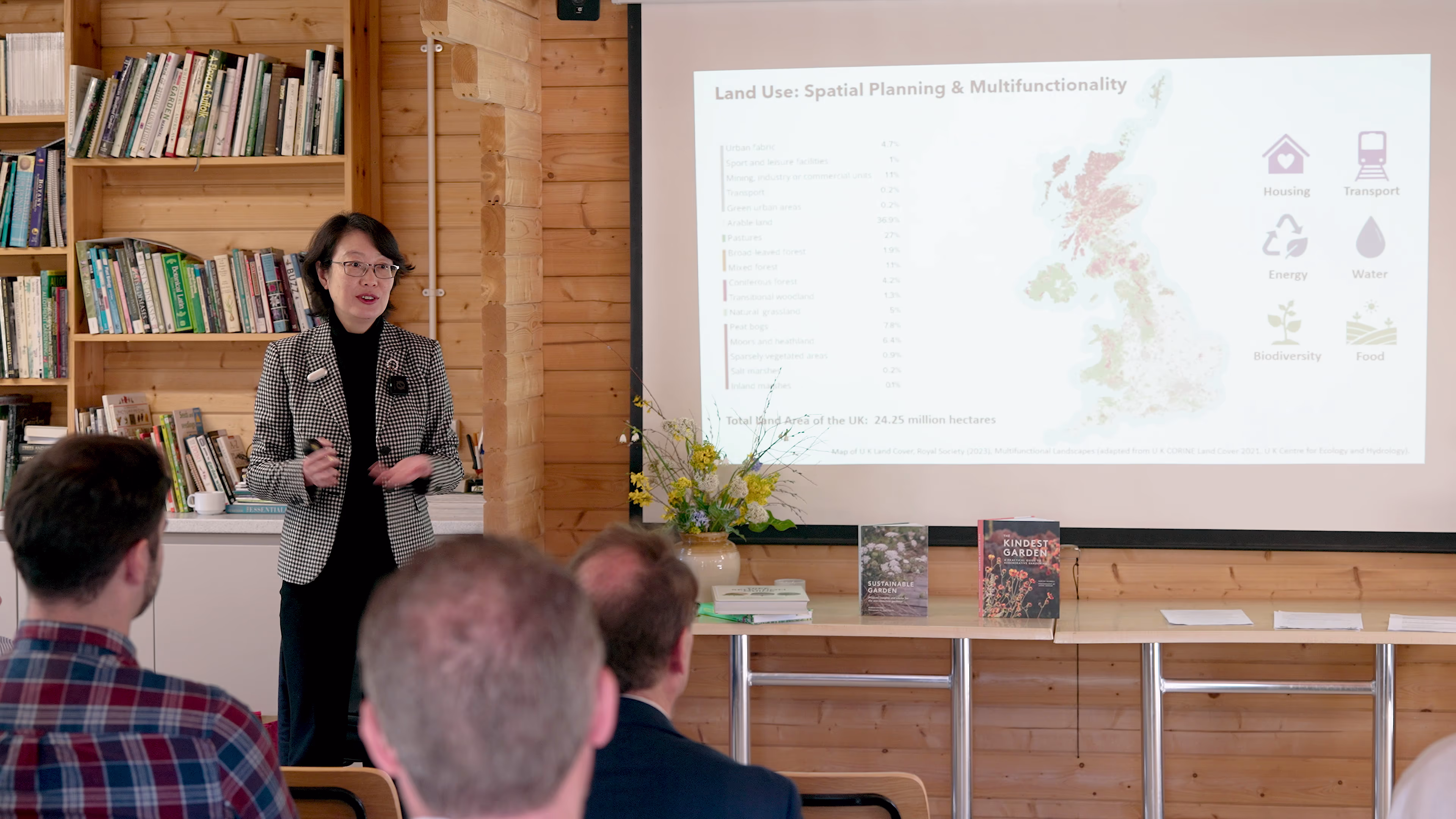 Guest speaker presenting beside a projected slide at the landscape workshop