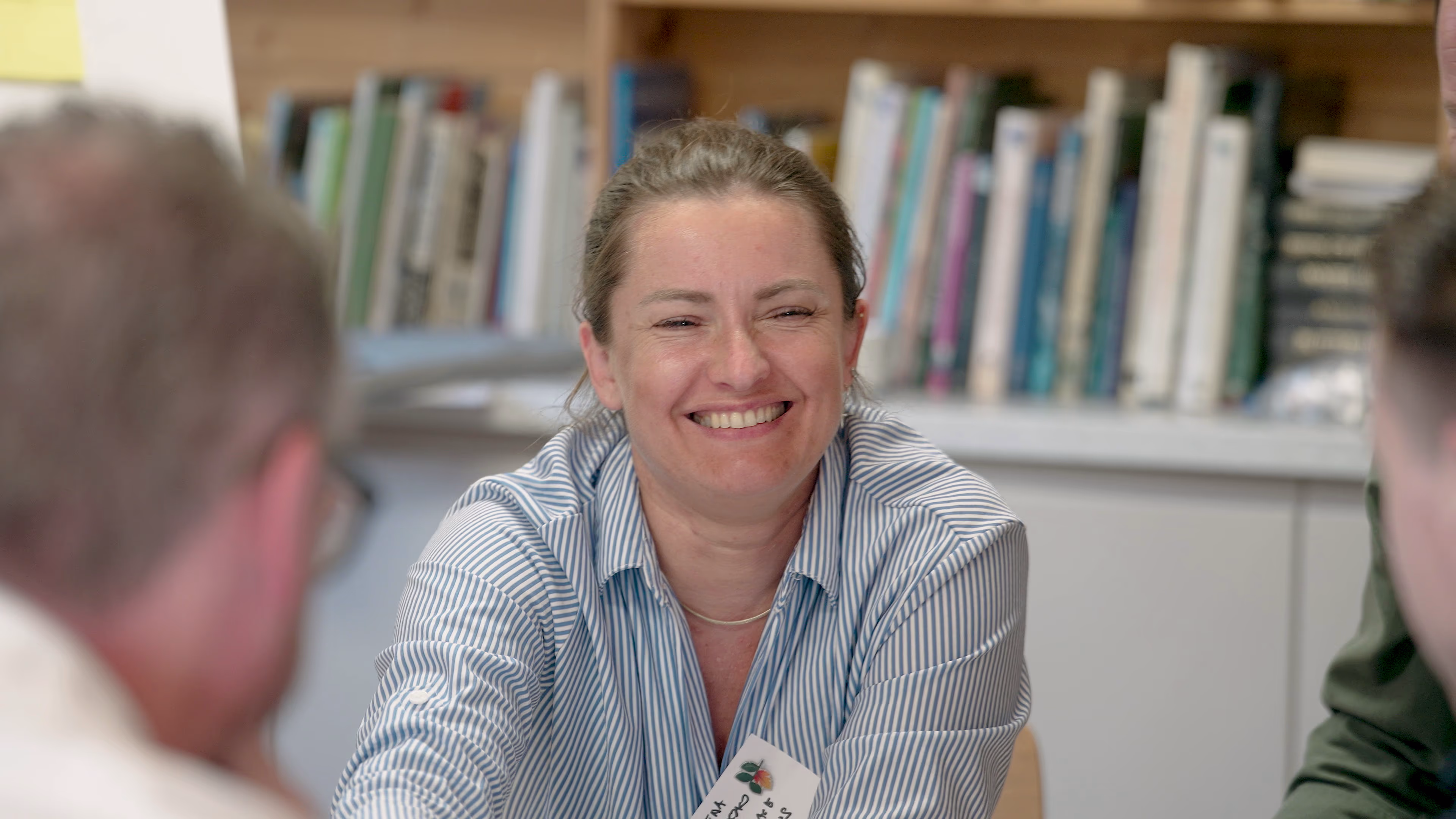 Smiling participant in conversation during the Beth Chatto Gardens workshop