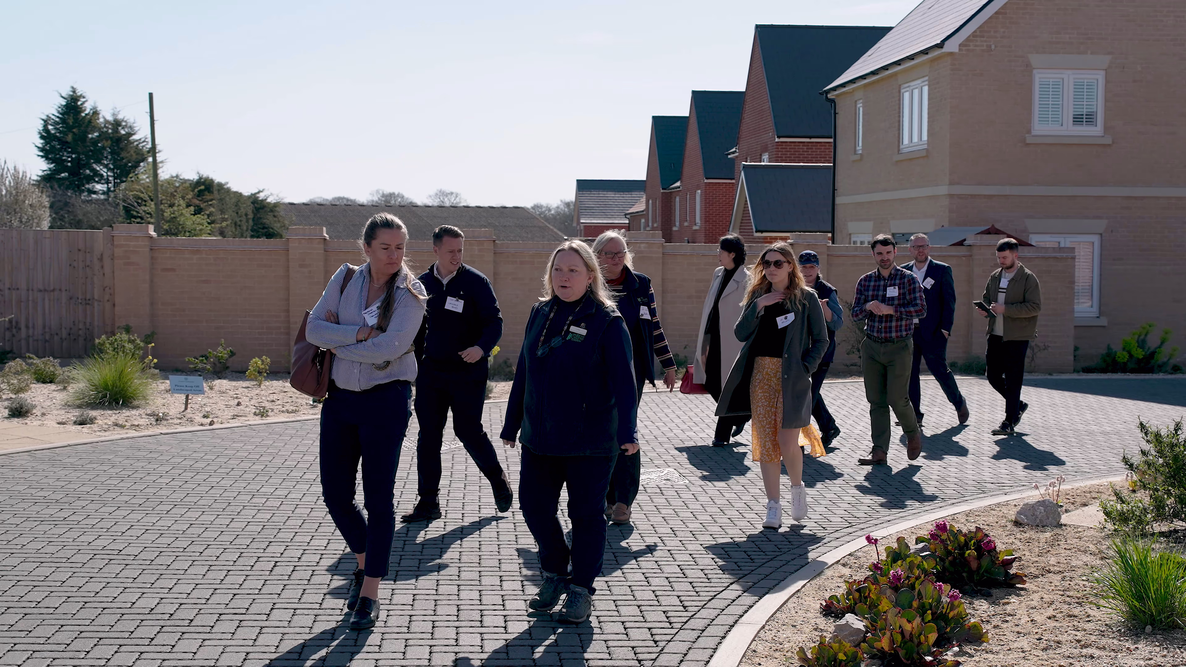 Workshop group walking past homes and planting during the Chattowood visit