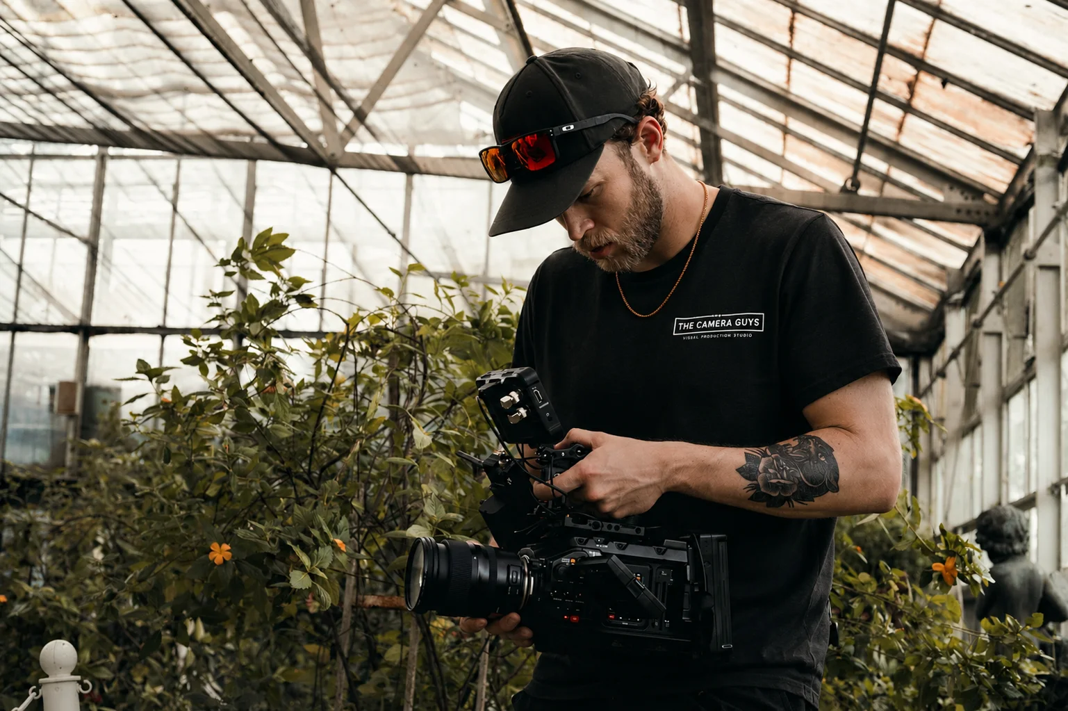 Videographer filming inside an operational greenhouse