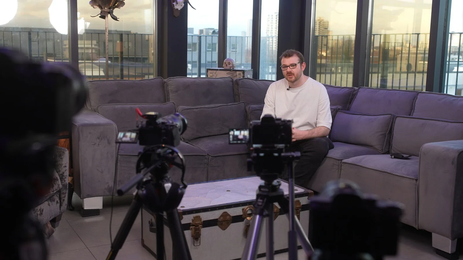 Two cameras recording a seated business interview