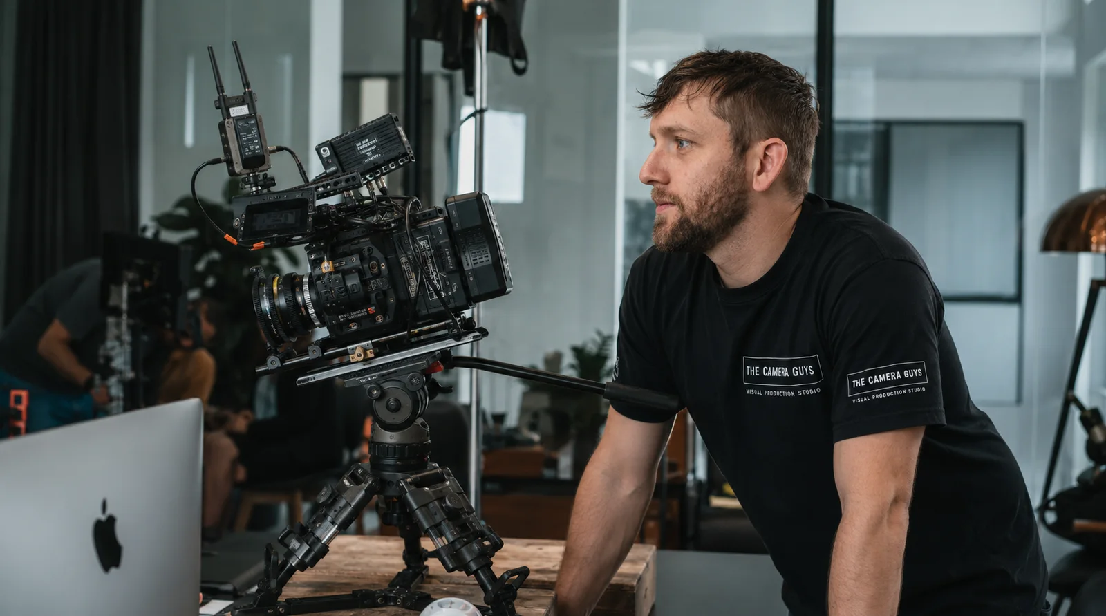 Videographer monitoring a cinema camera during an office production