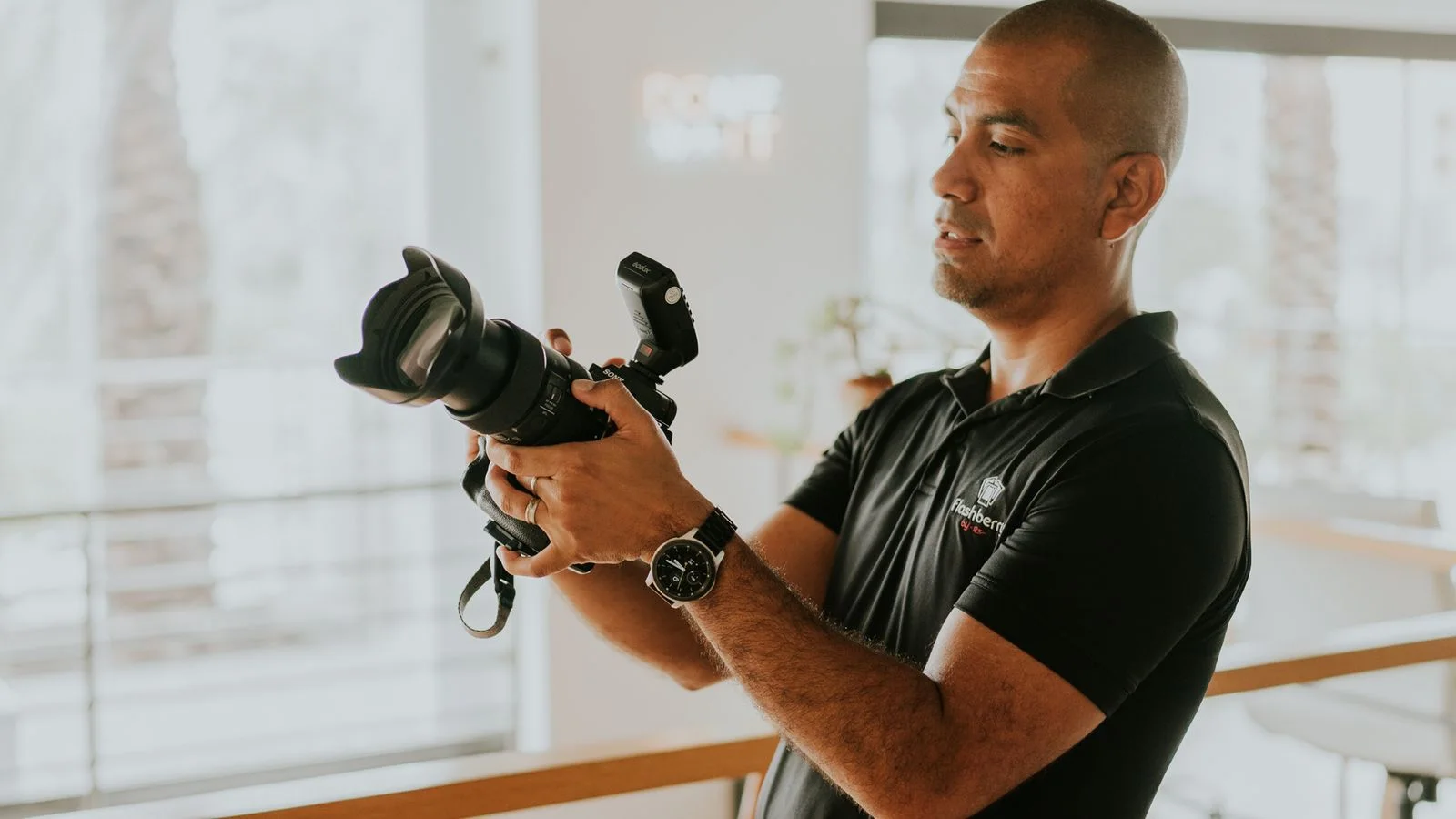 Professional photographer preparing a camera for a business assignment