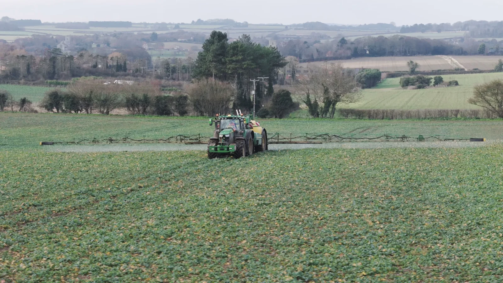 Tractor working across farmland during the Sentry film production