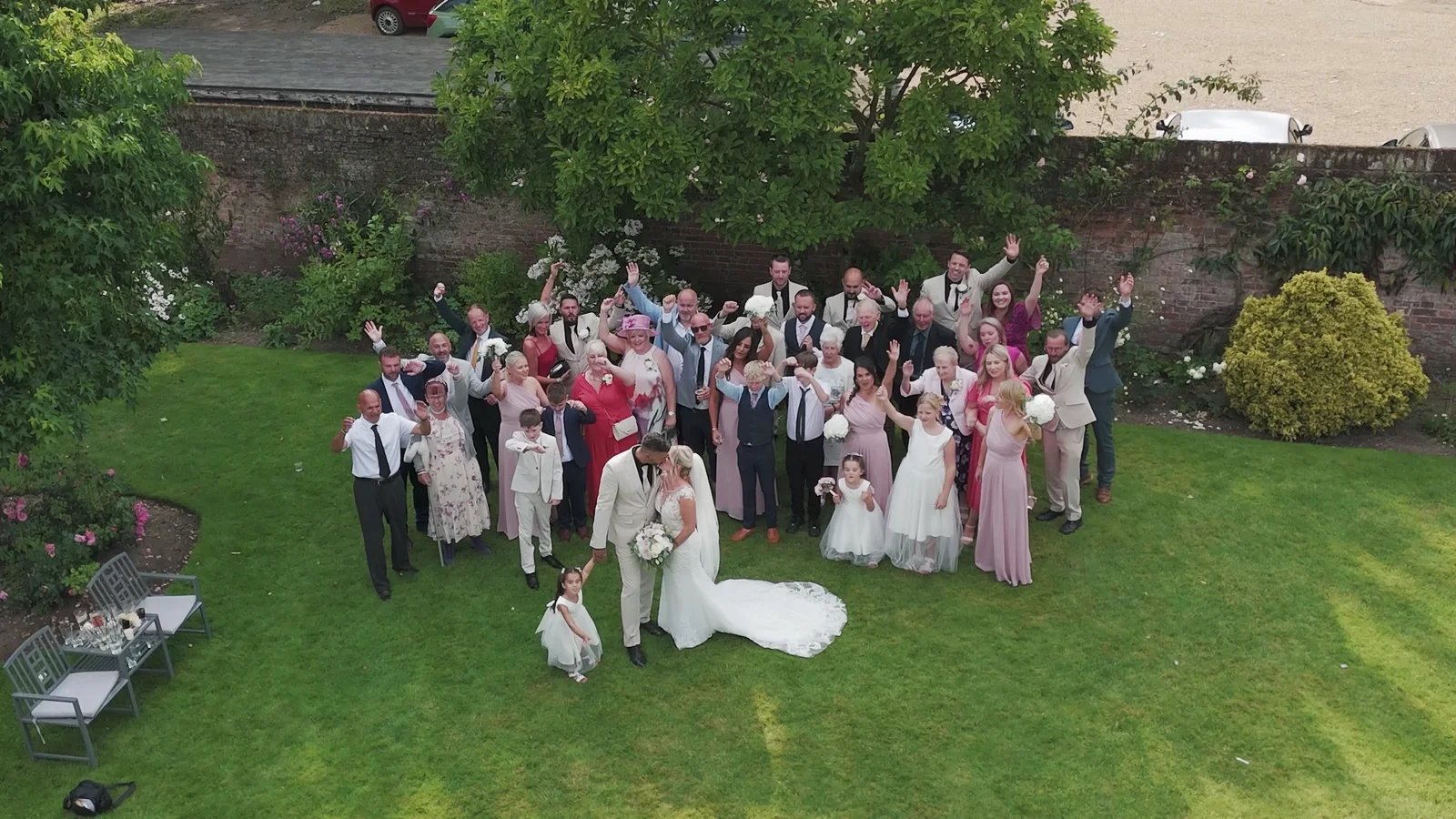 Aerial view of Jake and Lisa with their wedding guests in The Norfolk Mead grounds