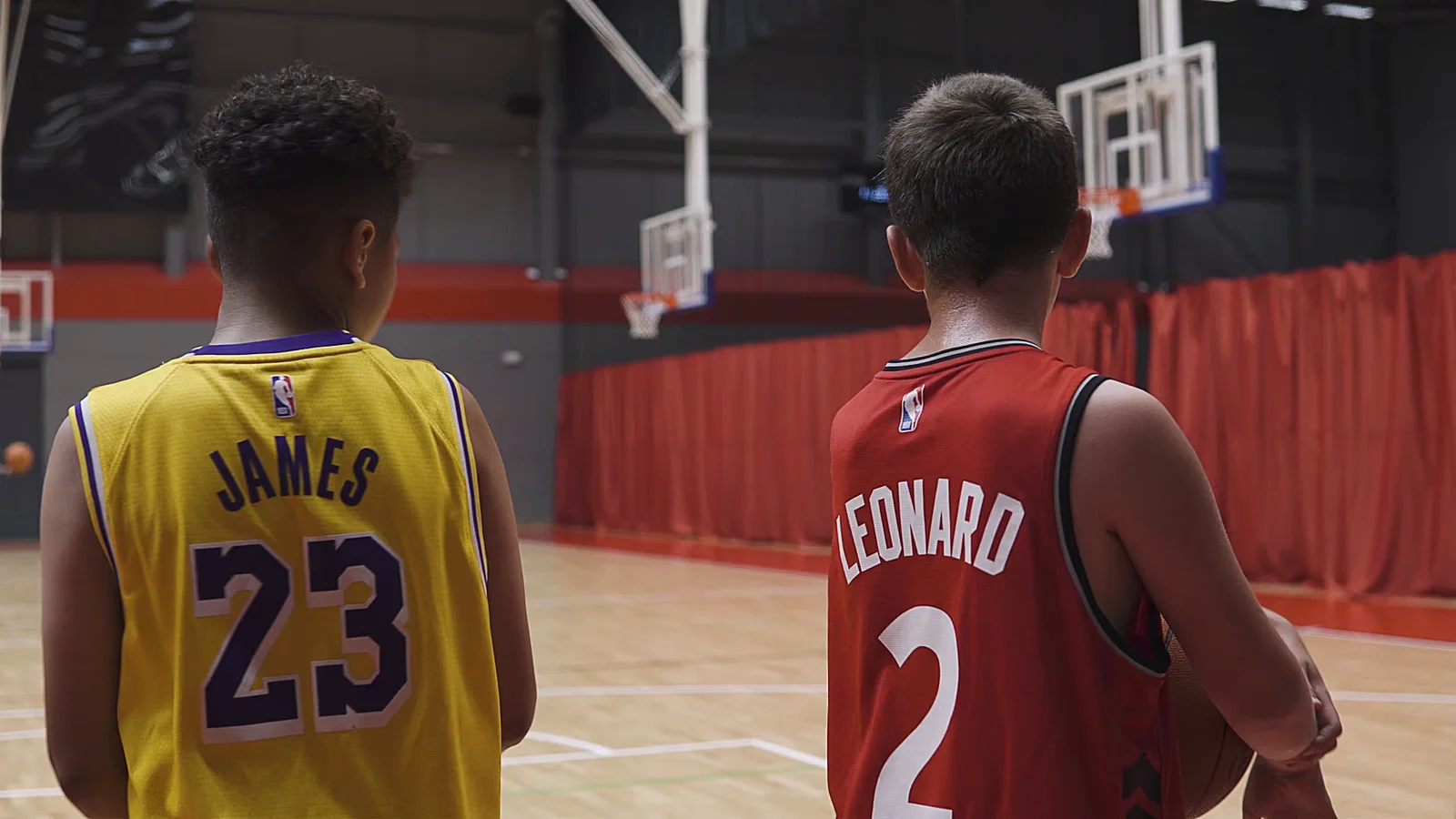 Basketball players standing on the Essex Sport Arena court