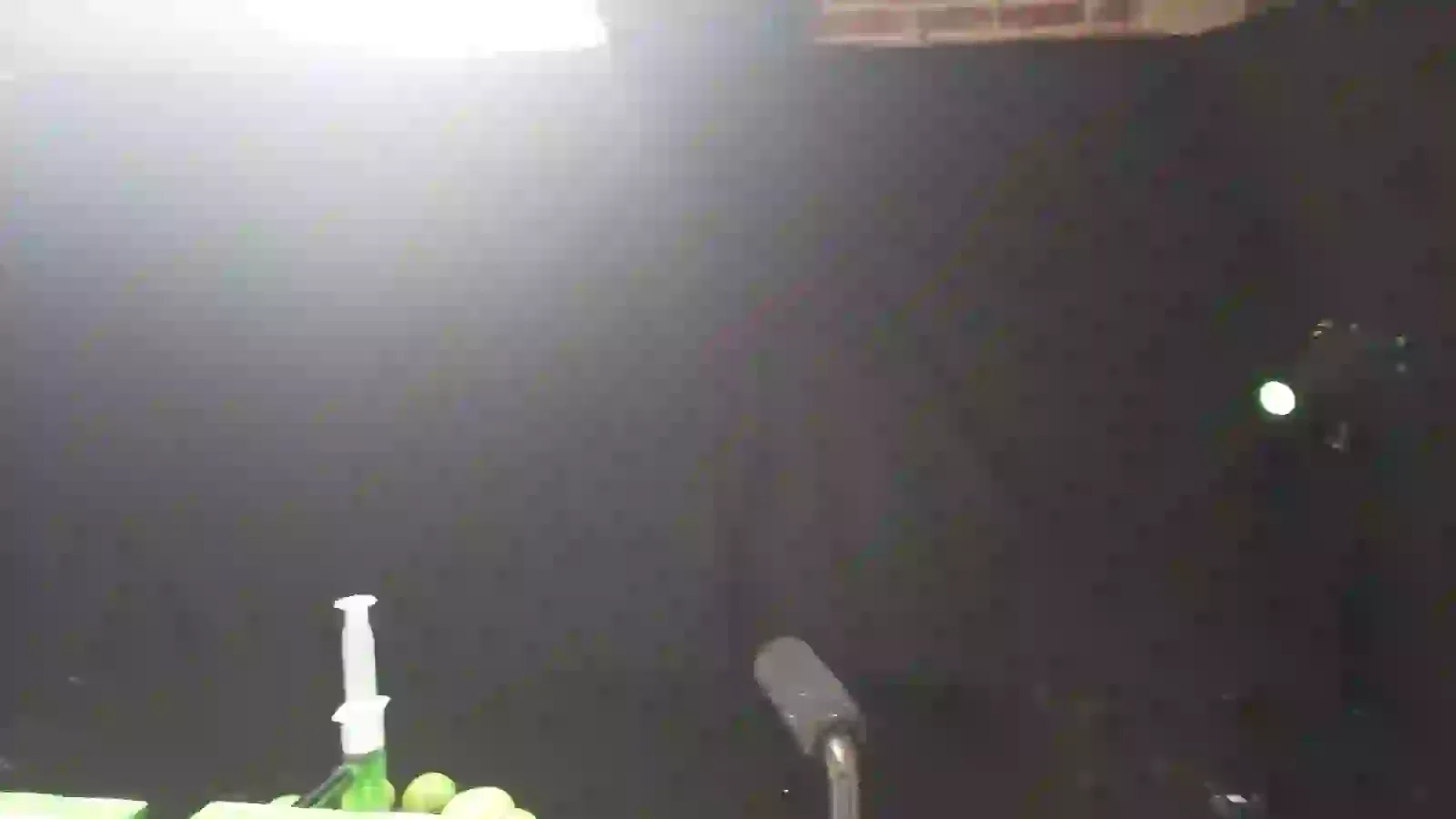 Phone-video frame showing the black-cloth Jellyshotz kitchen setup