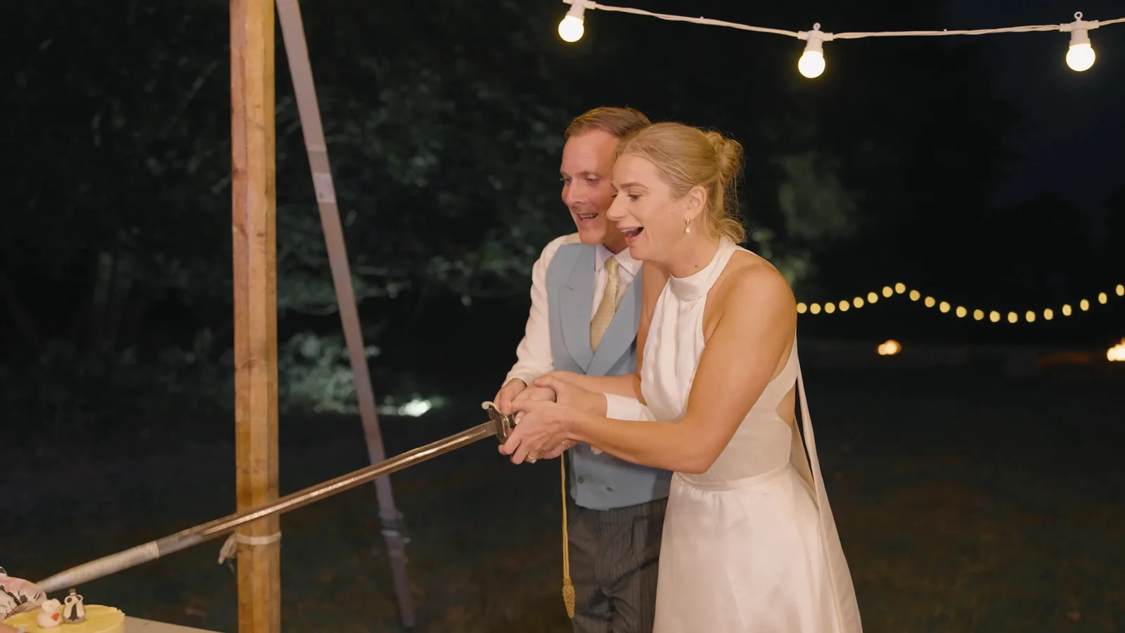 Harriet and Luke dancing beneath evening lights