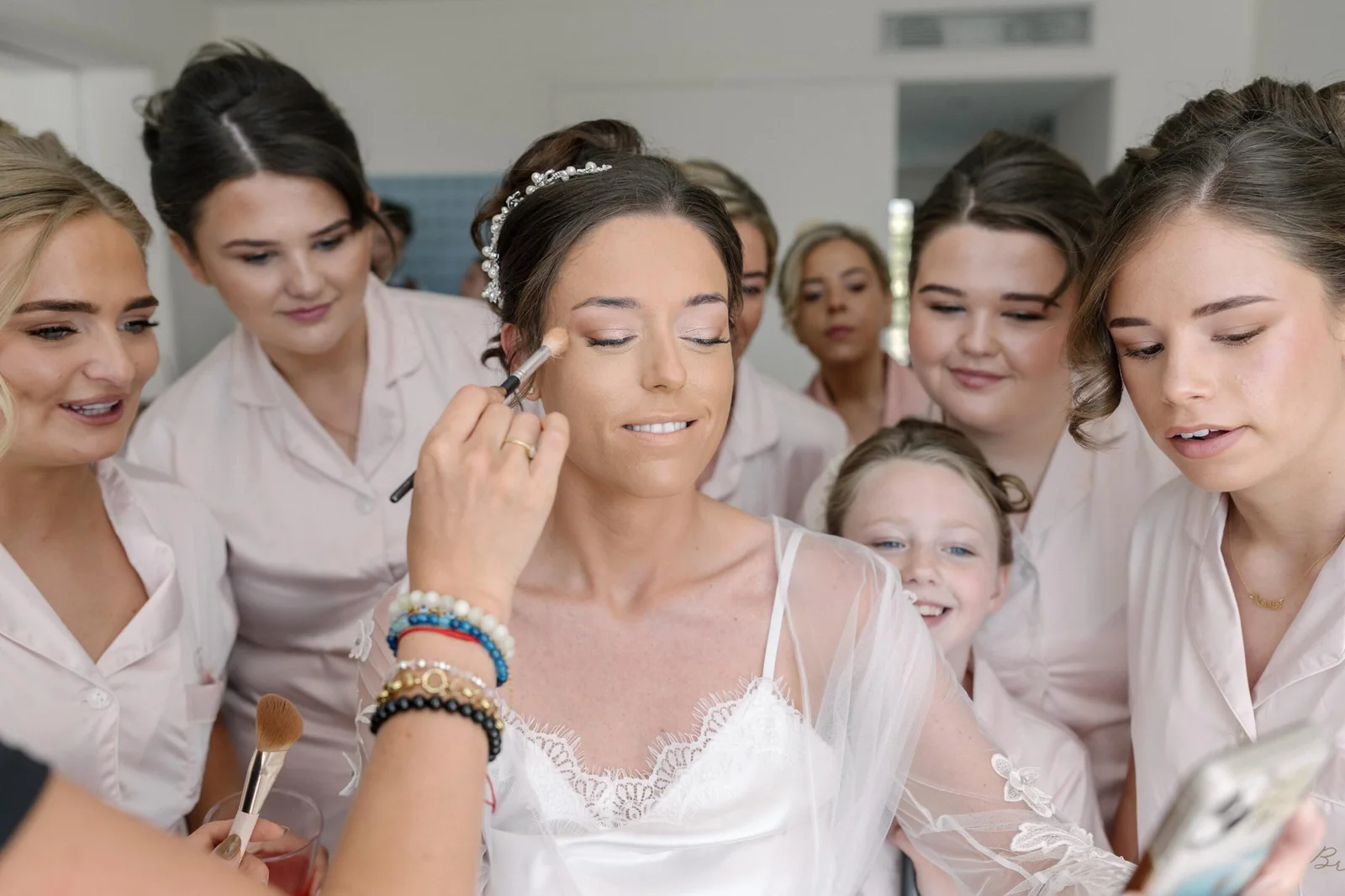 The bridal party gathered around Ellie during preparations