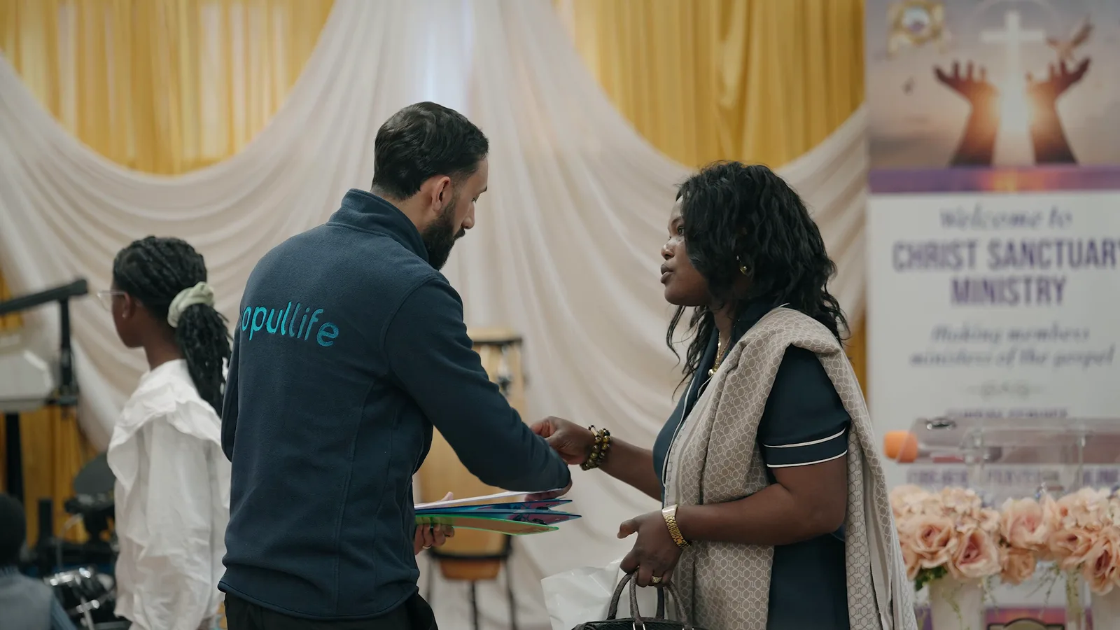 Opul Life representative greeting a community member during an Essex outreach visit