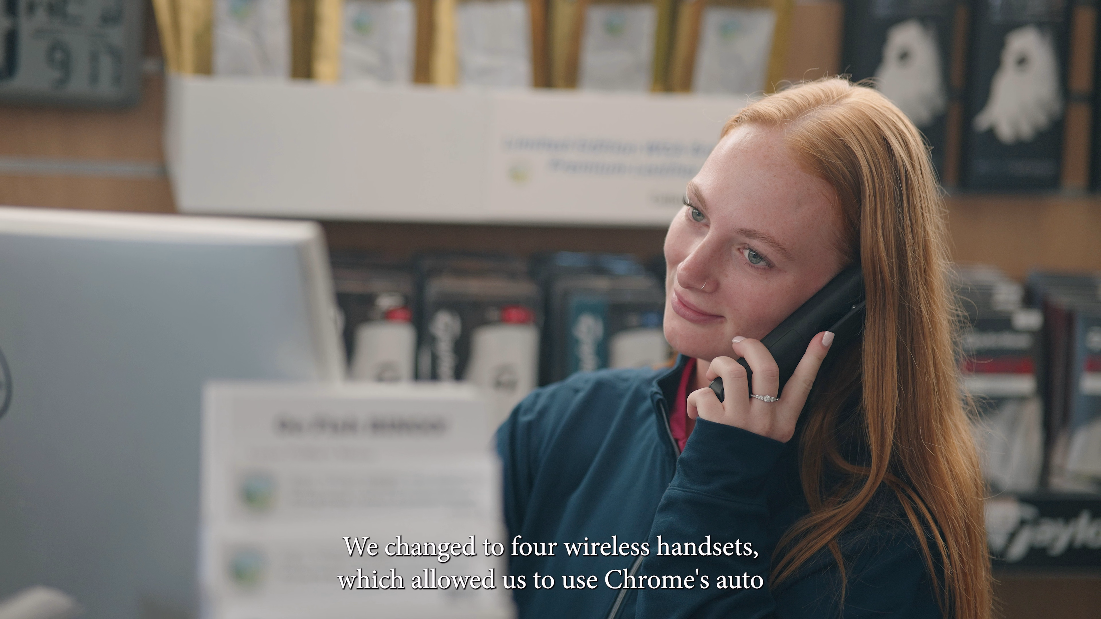 Staff member using a telephone at the Winchester Golf Academy counter