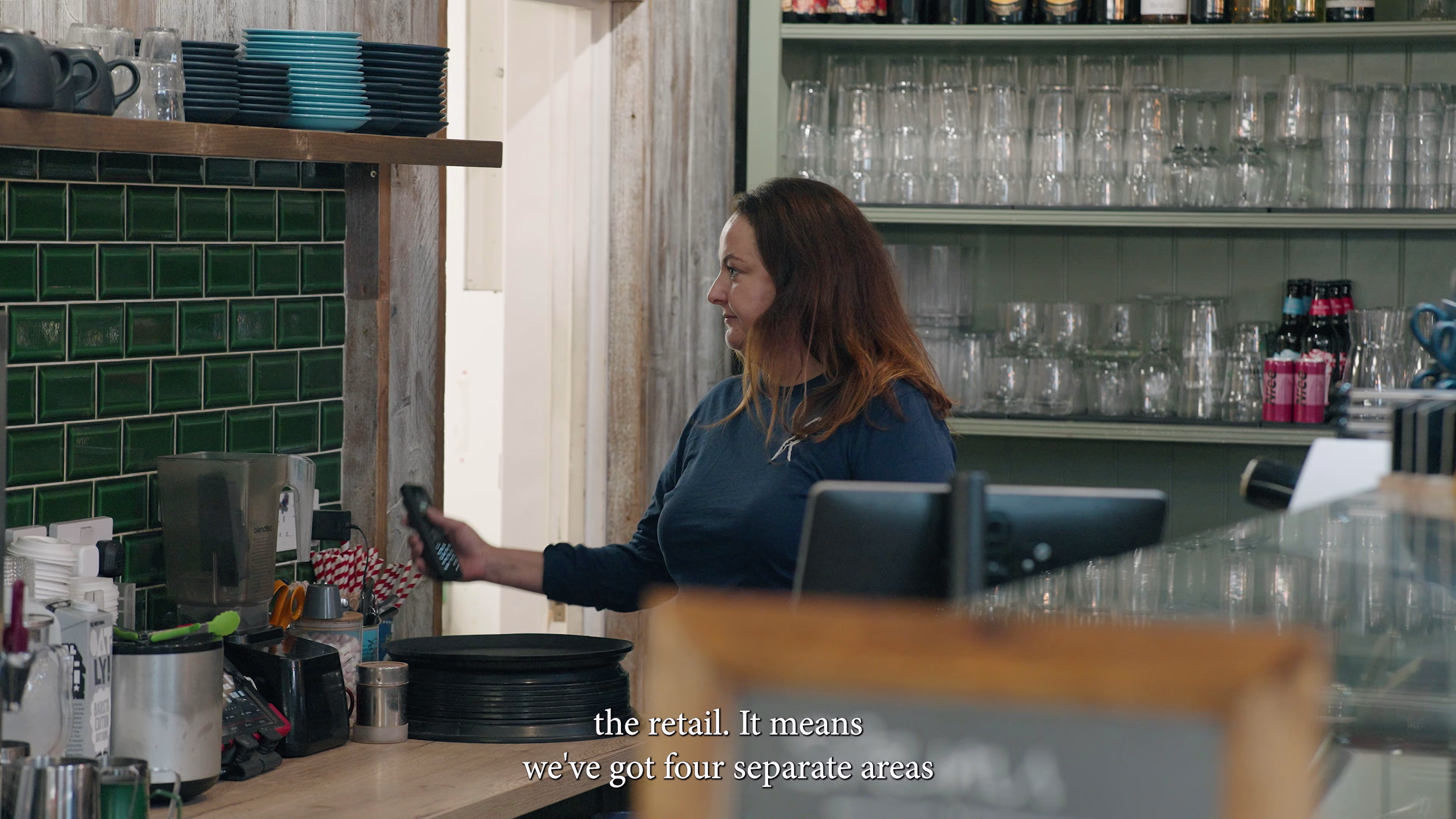 Staff member at the café counter inside Winchester Golf Academy