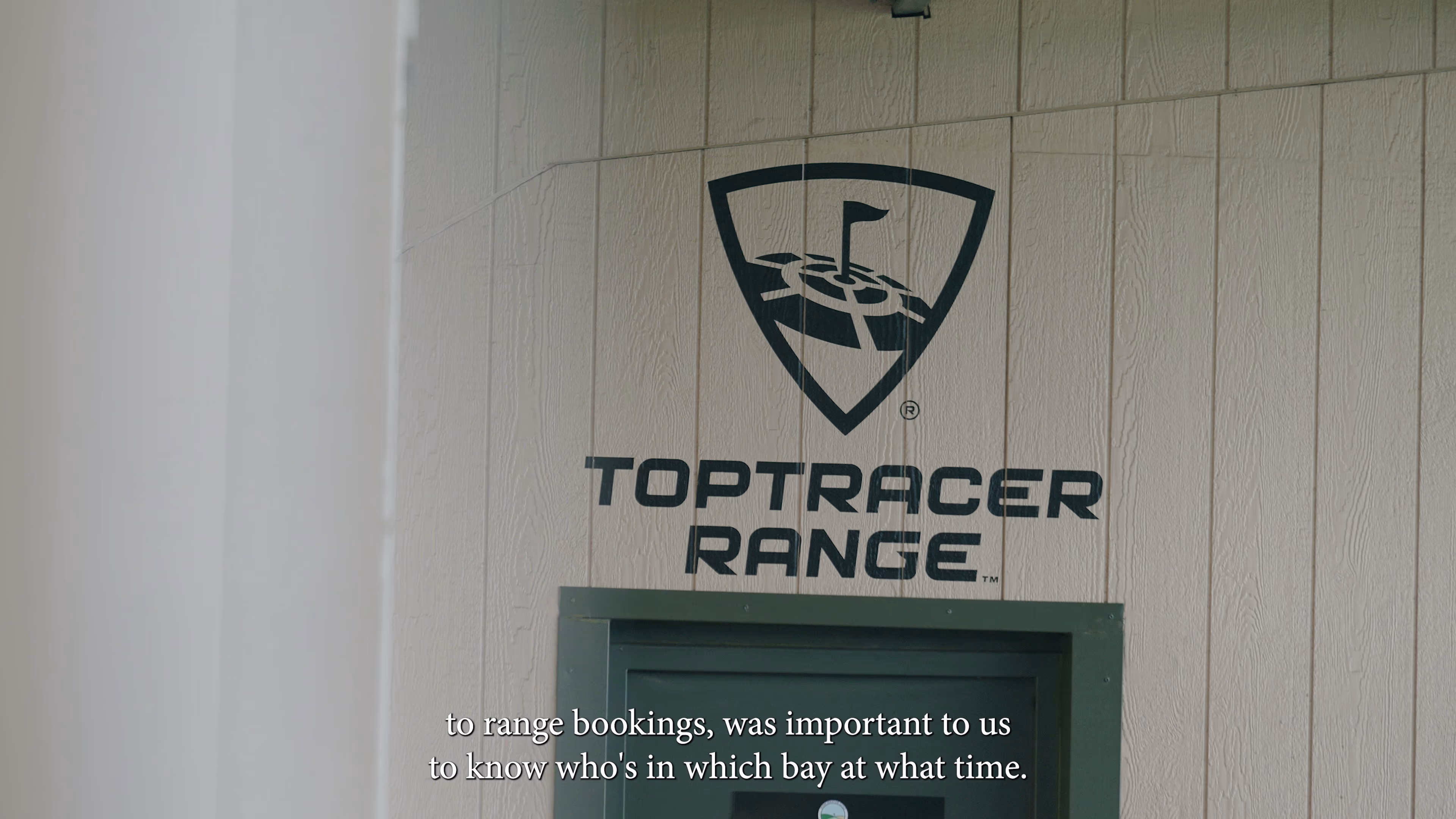 Toptracer Range sign above a doorway at Winchester Golf Academy