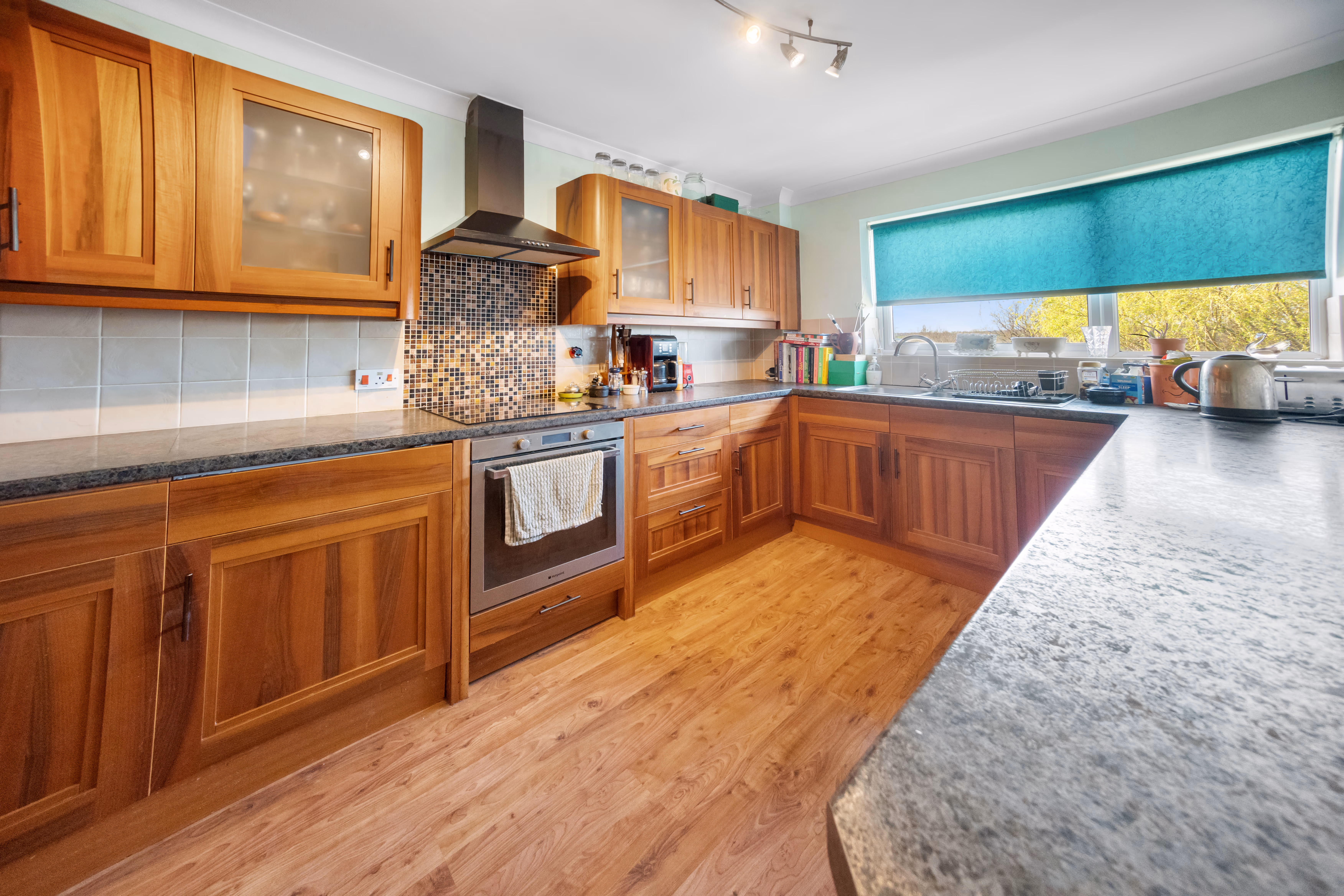 Kitchen with timber cabinets and dark worktops — 13 Furness Close