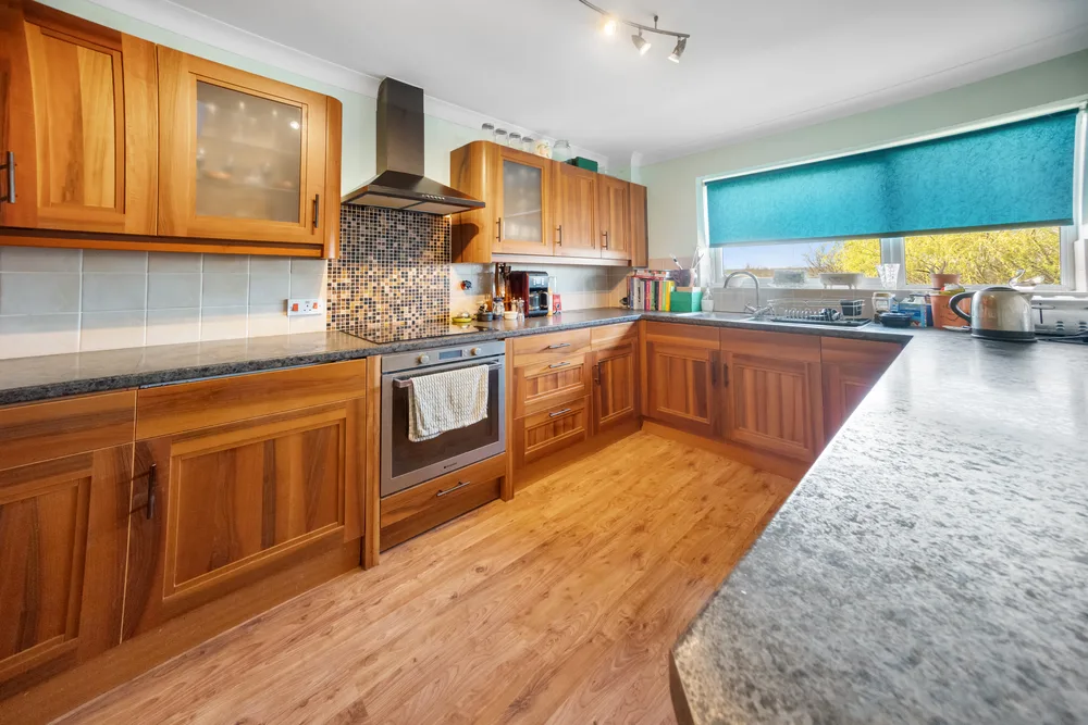 Kitchen with timber cabinets and dark worktops — 13 Furness Close