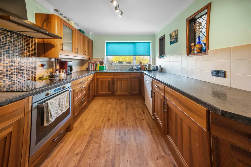 Kitchen opening towards the adjoining room — 13 Furness Close