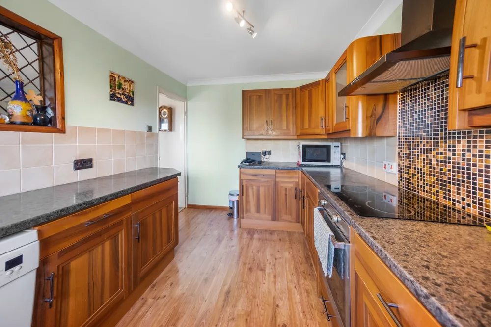 Kitchen with tiled floor and timber cupboards — 13 Furness Close