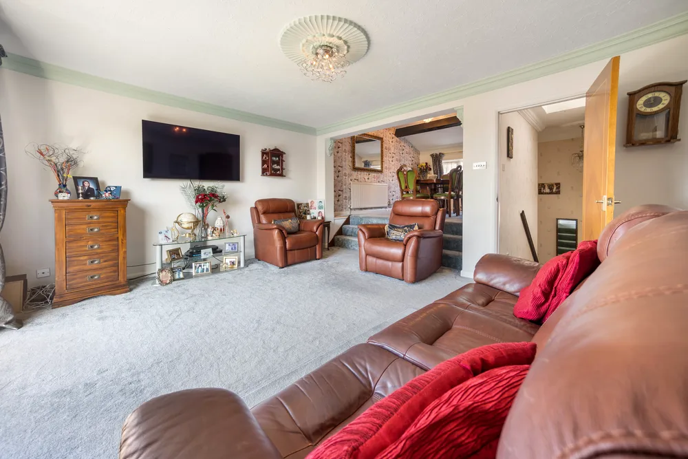 Living room with red sofas — 13 Furness Close