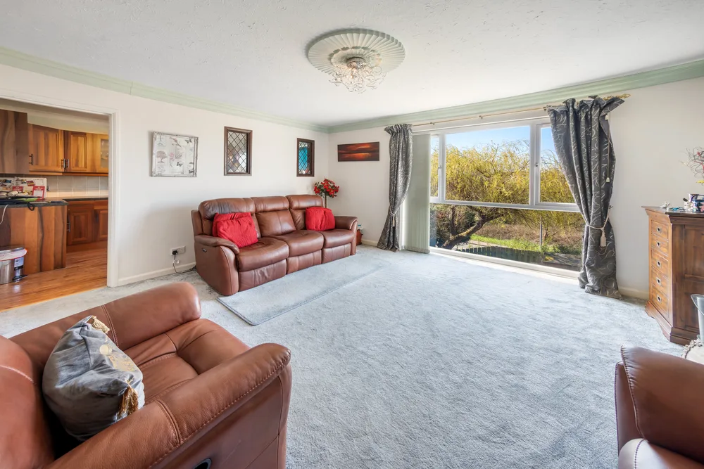Living room with broad garden-facing windows — 13 Furness Close
