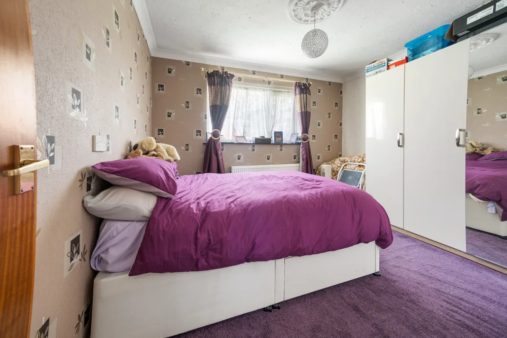 Bedroom with purple bedding — 13 Furness Close