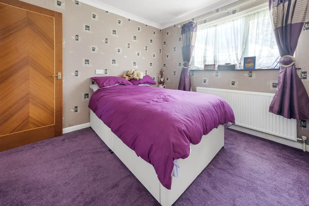 Bedroom with purple bedding and fitted storage — 13 Furness Close