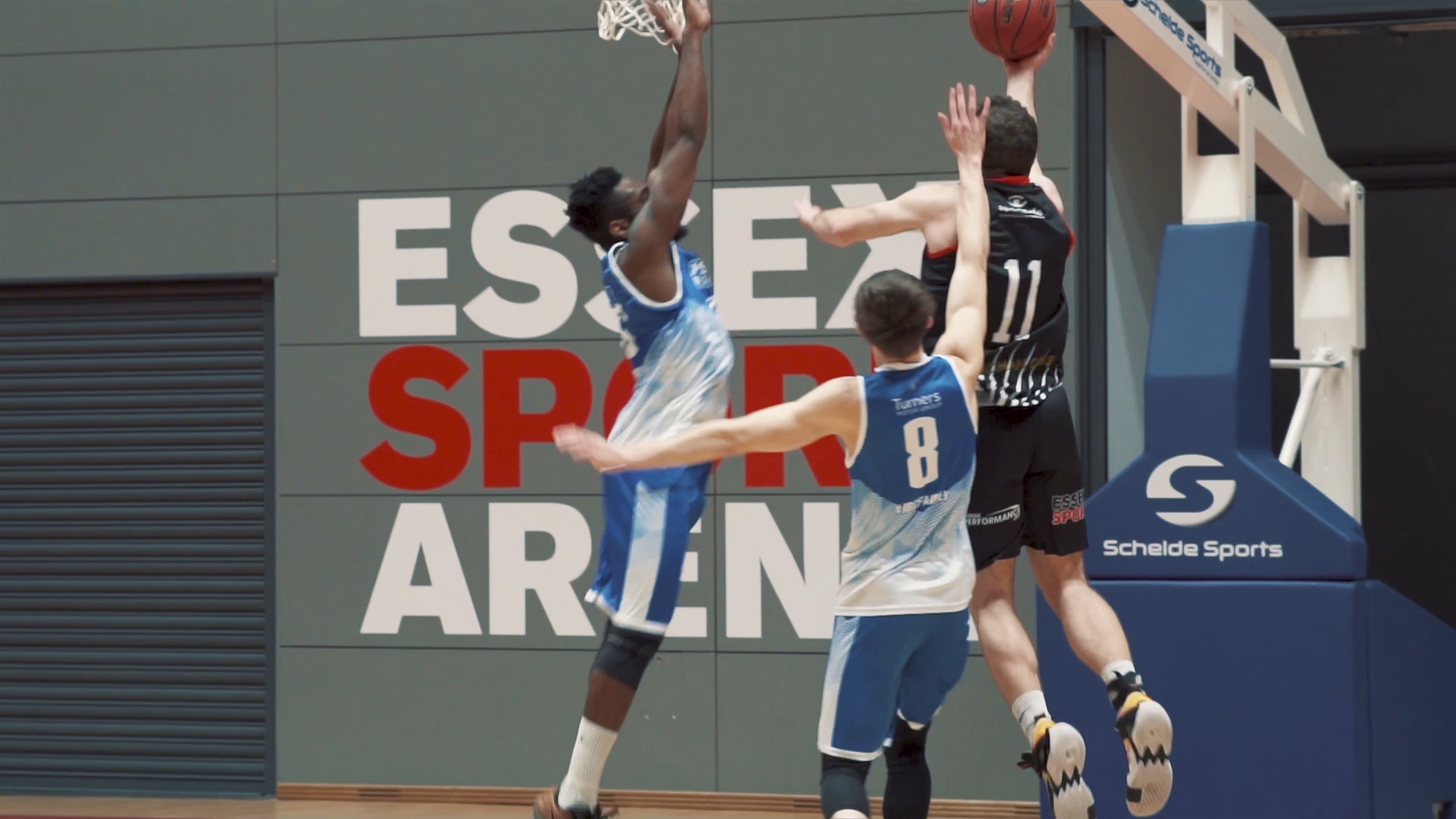 Men's basketball player shooting over a defender