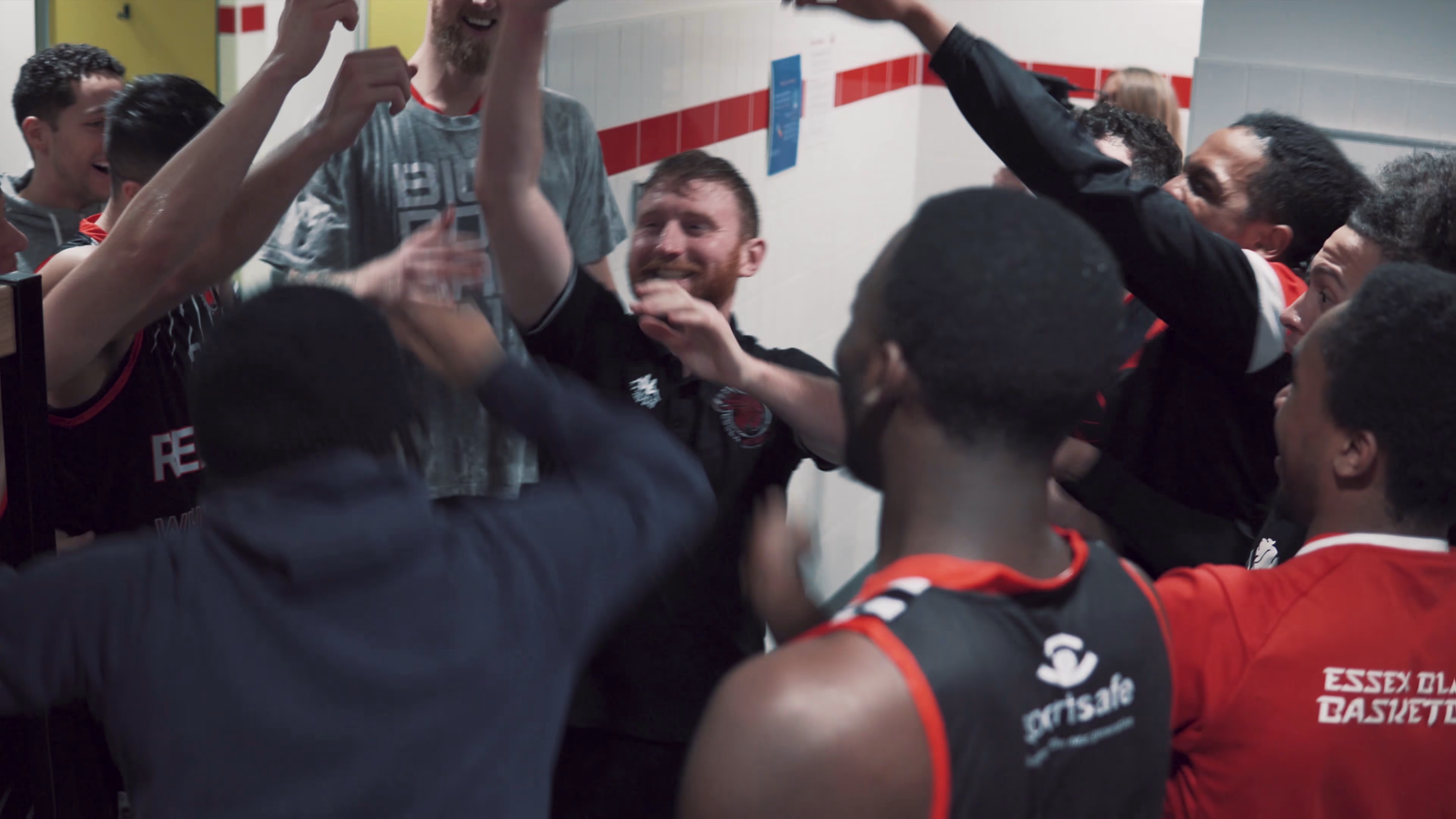 Essex Rebels players and staff gathering in a team huddle