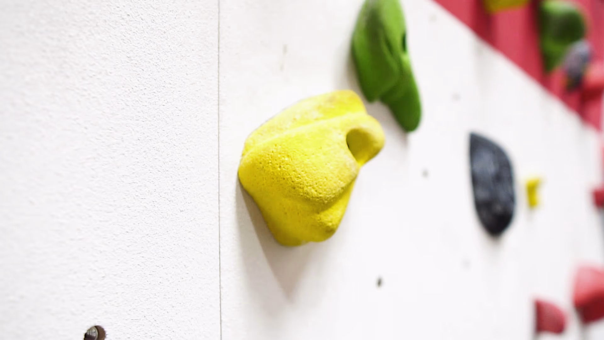 Close-up of a yellow climbing hold on the Essex Sport wall