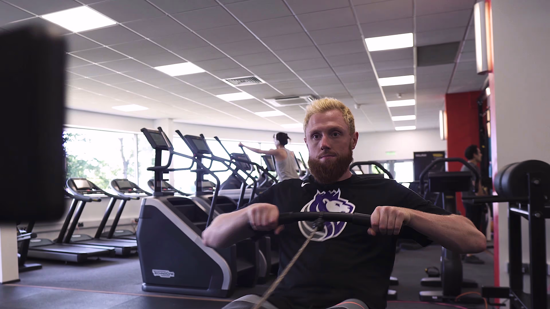 Gym member exercising on a rowing machine