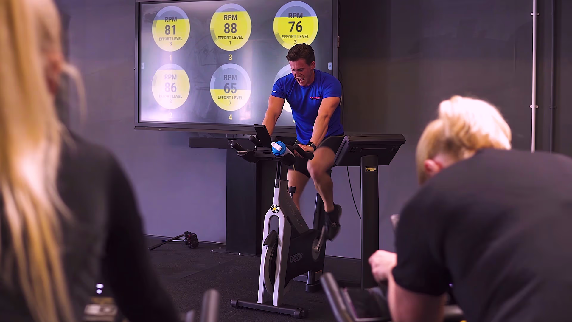 Instructor and participants in an Essex Sport cycling studio
