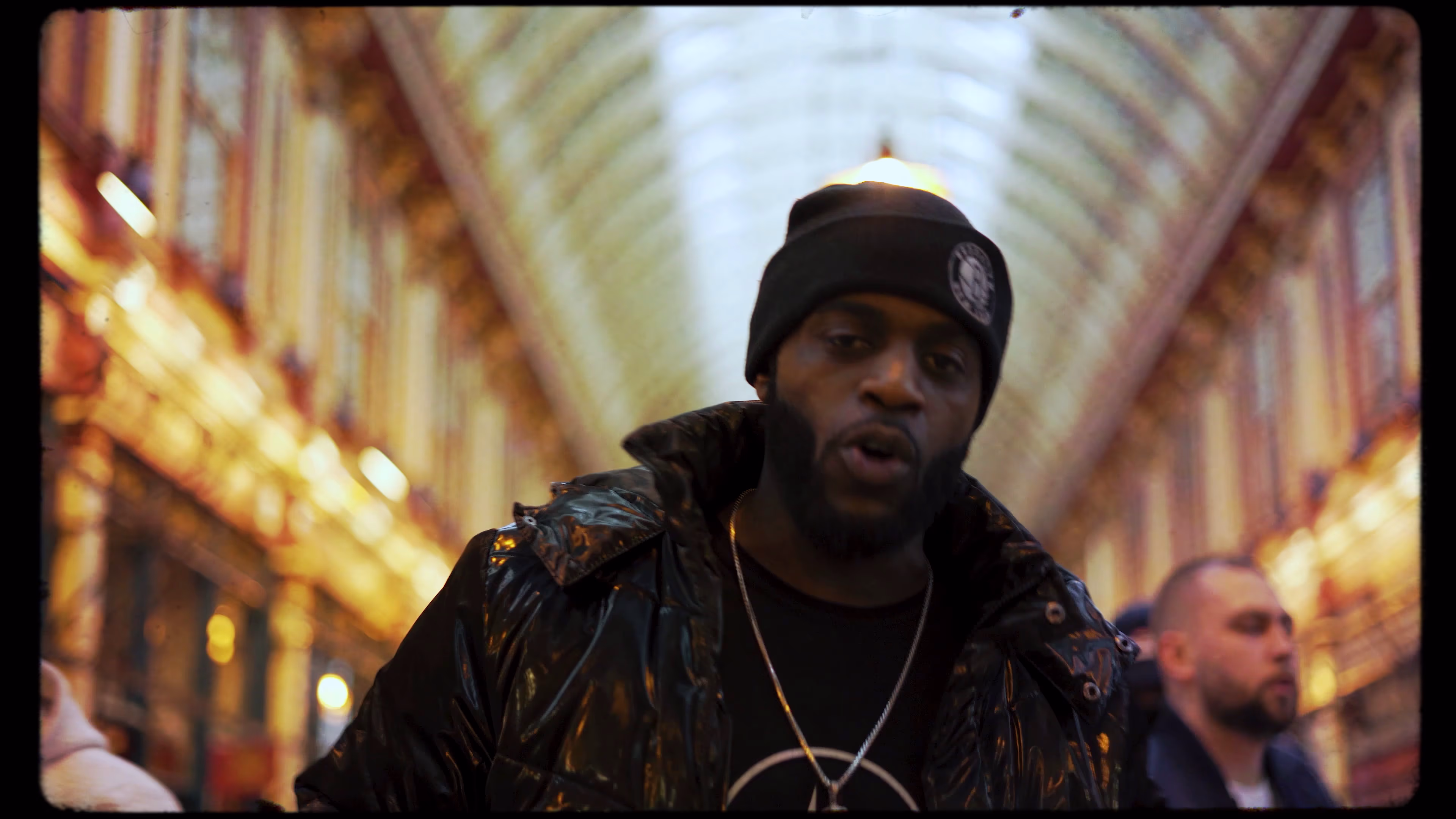 Close handheld performance framed by Leadenhall Market’s covered arcade