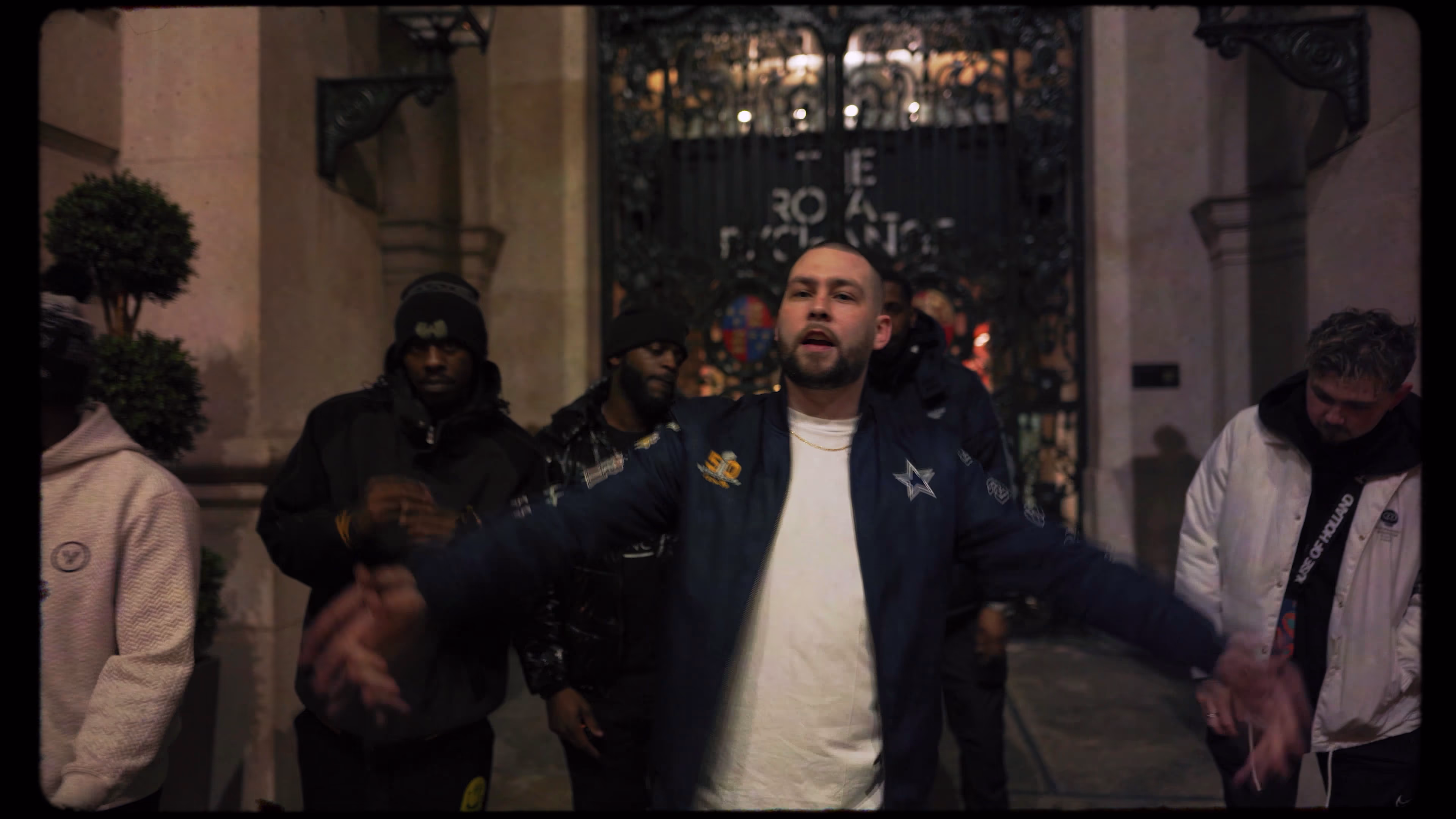 New Guardz member leading a group performance in a stone doorway