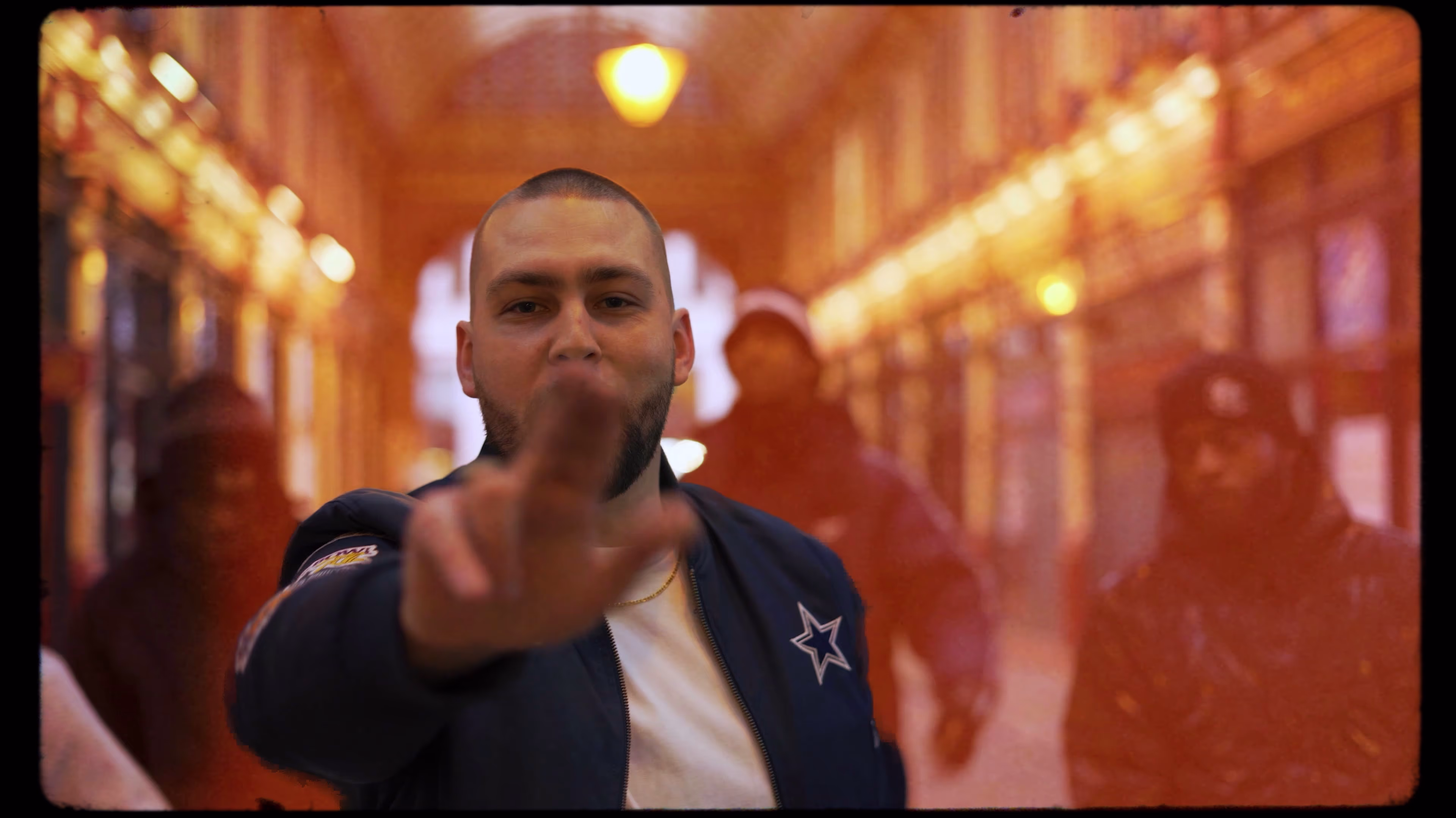 Warm light-leak treatment on a New Guardz performance at Leadenhall Market