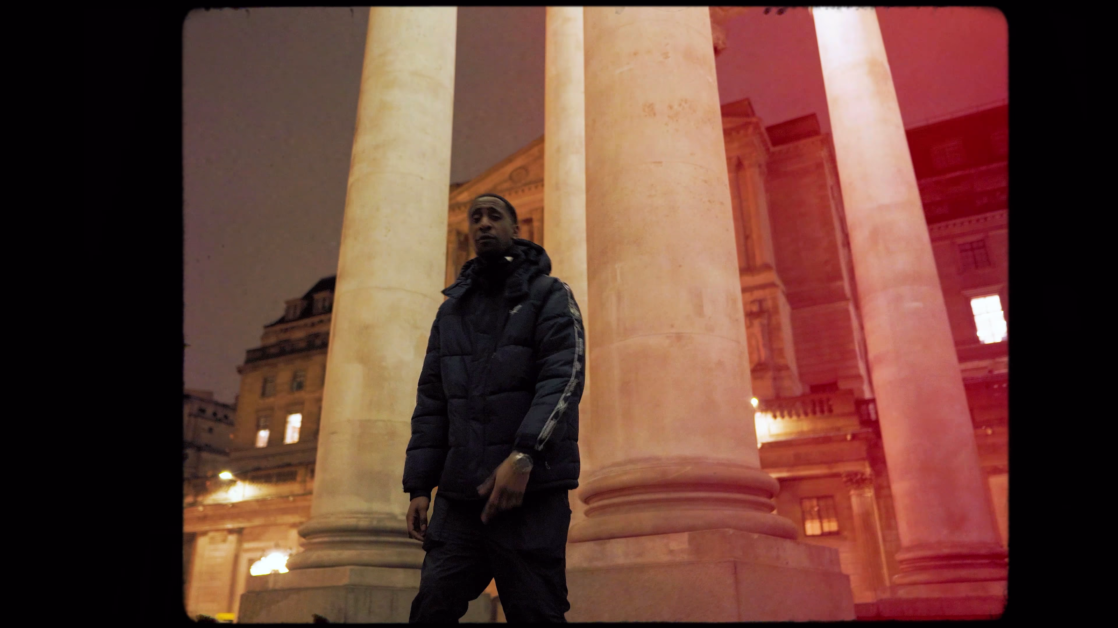 Low-angle New Guardz performance between illuminated stone columns