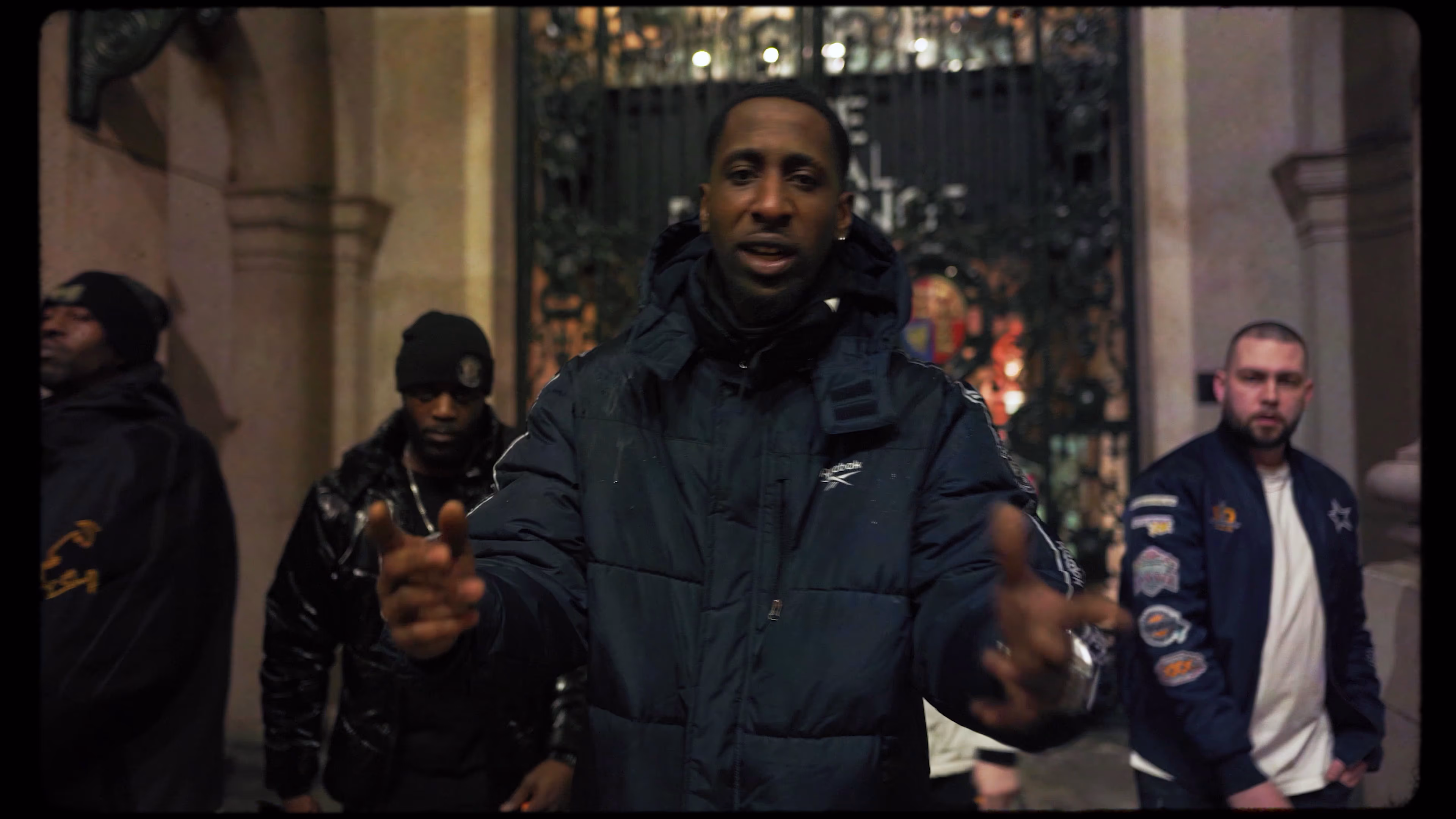 Group performance outside an ornate London doorway