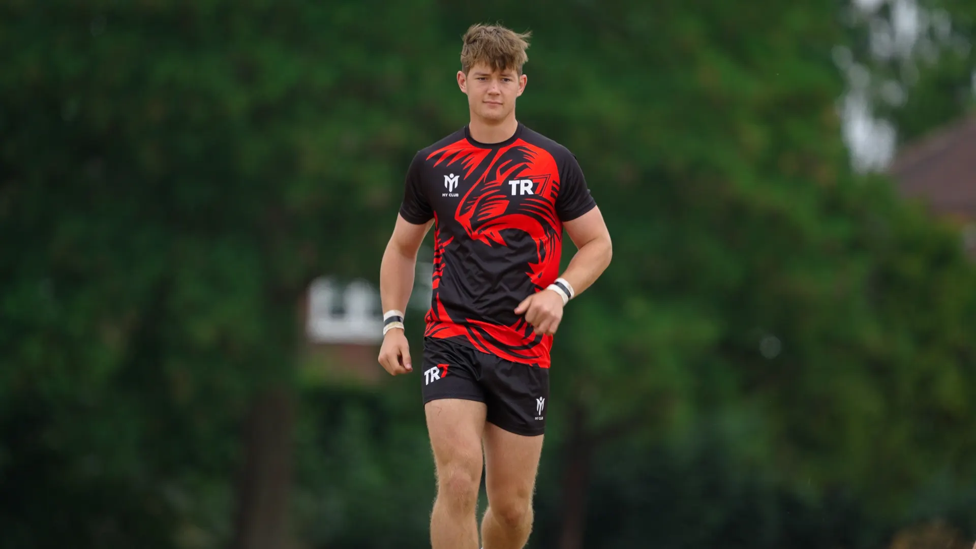 TR7 player in the red and black warm-up kit