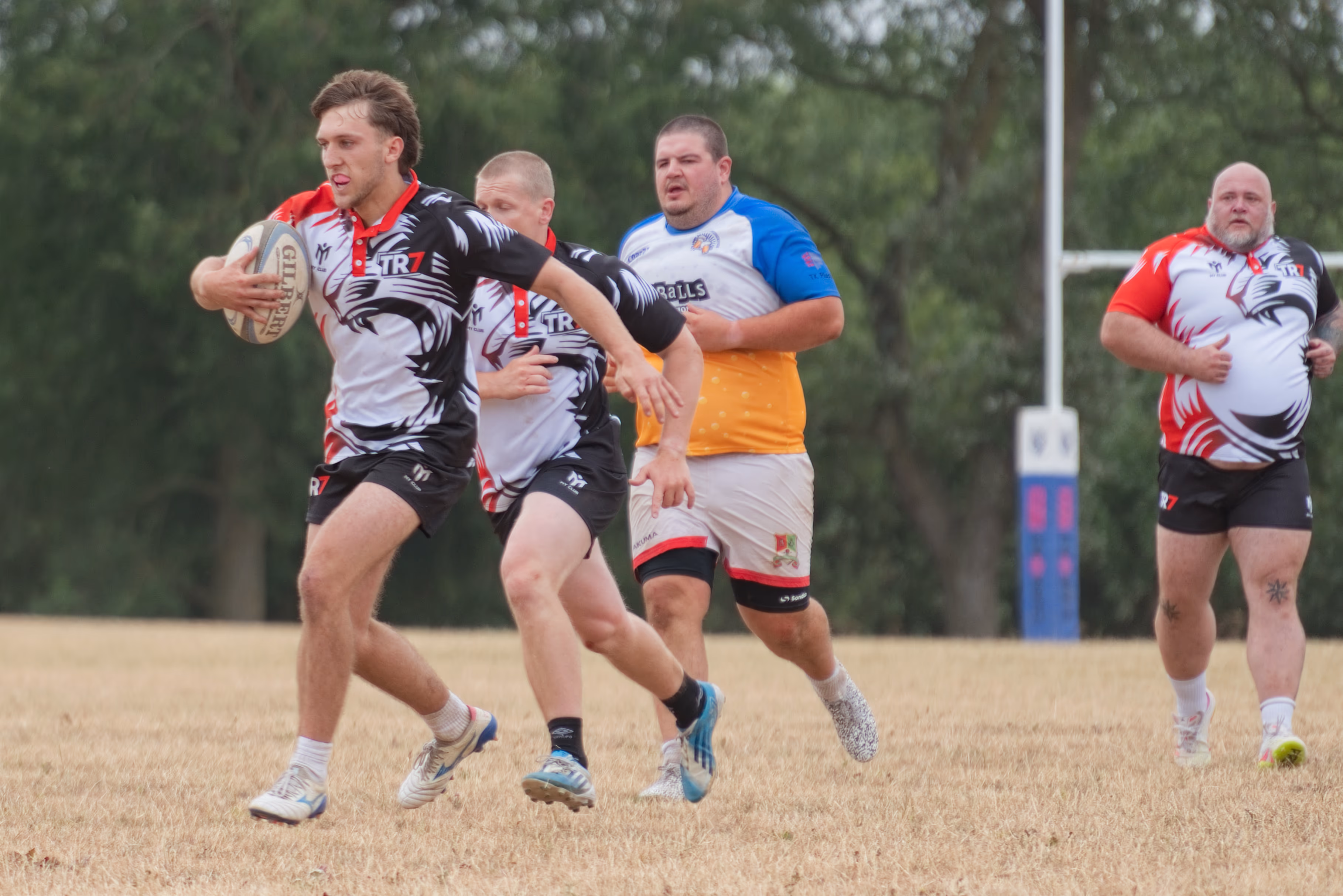 TR7 ball carrier running past an opponent at Rugby St Andrews RFC