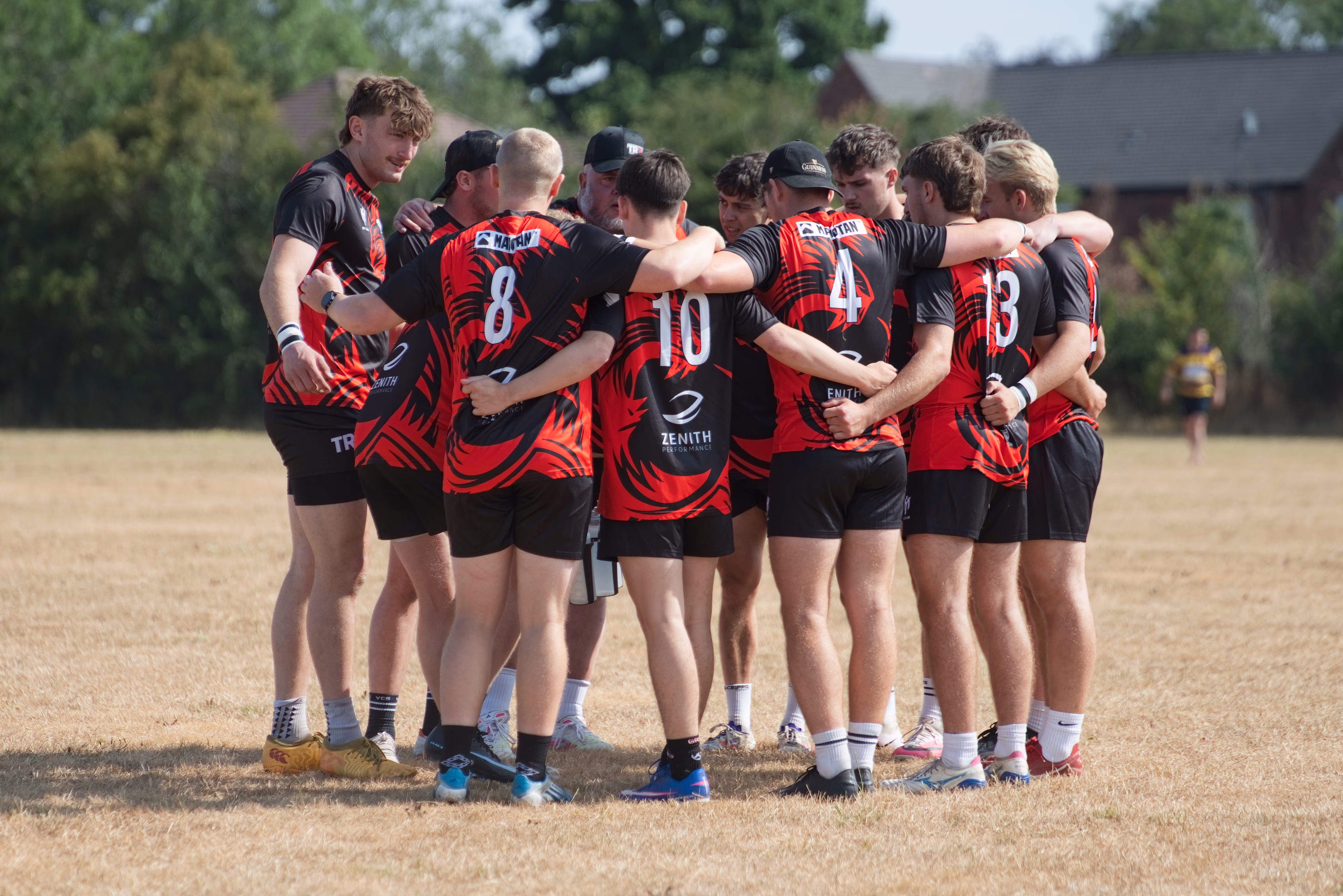 TR7 squad huddled in their red and black shirts at Hamplified