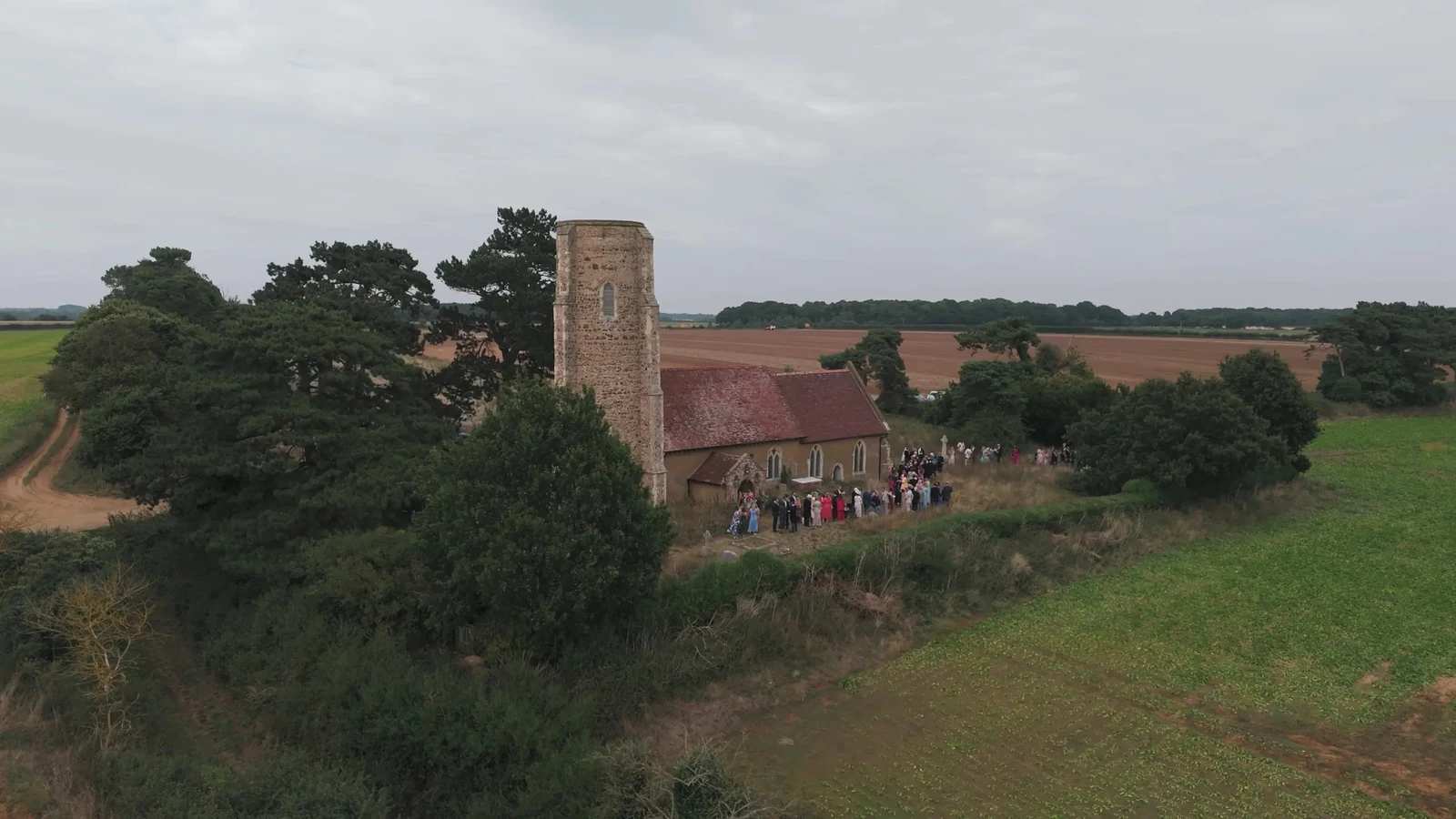 Film still: All Saints Church in Ramsholt surrounded by fields